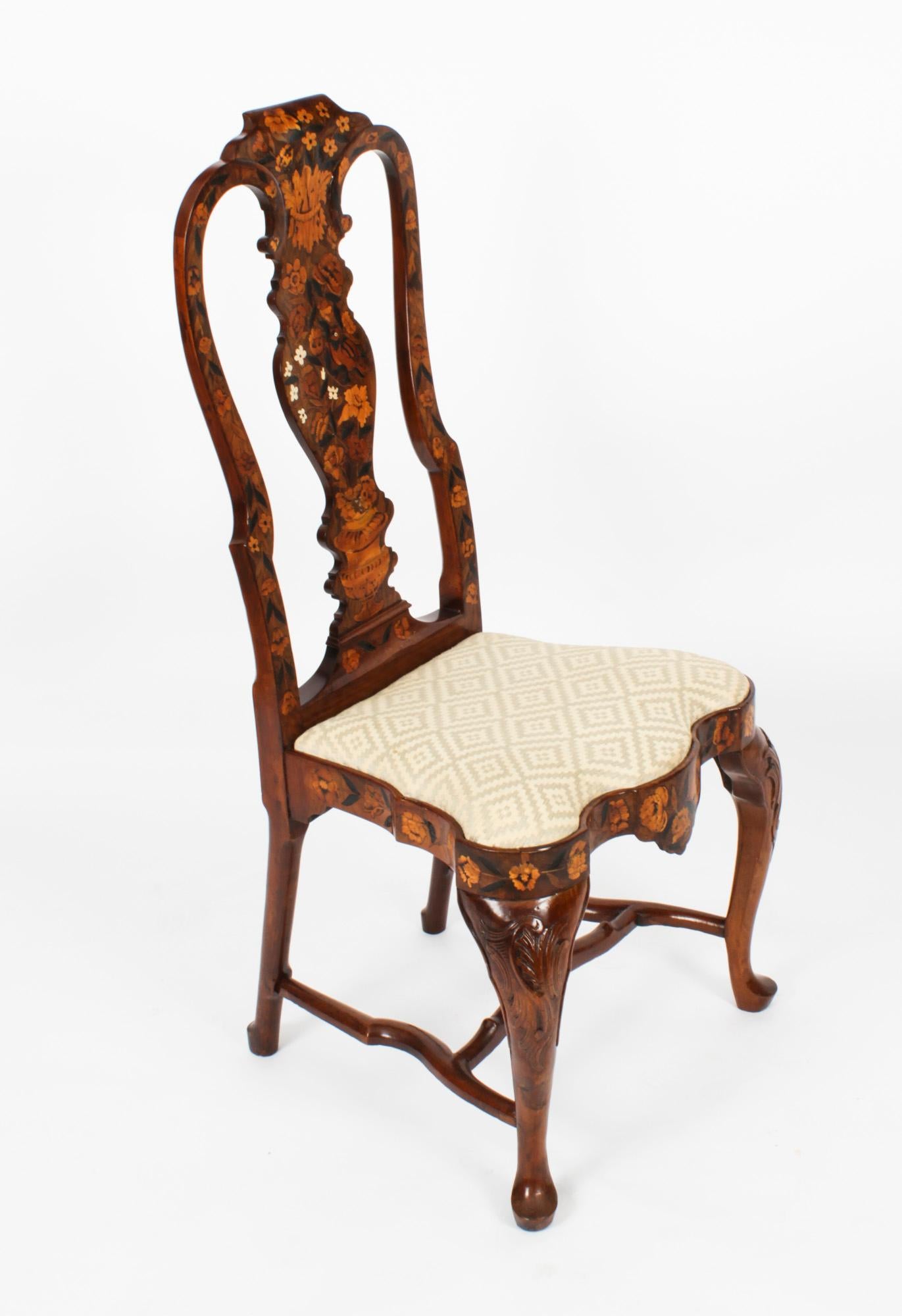 This is a wonderful and rare pair of high backed Dutch walnut and floral marquetry dining chairs, Circa 1780 in date.

The chairs have been skillfully crafted from walnut, bear profuse floral marquetry inlaid decoration and are typical of the very