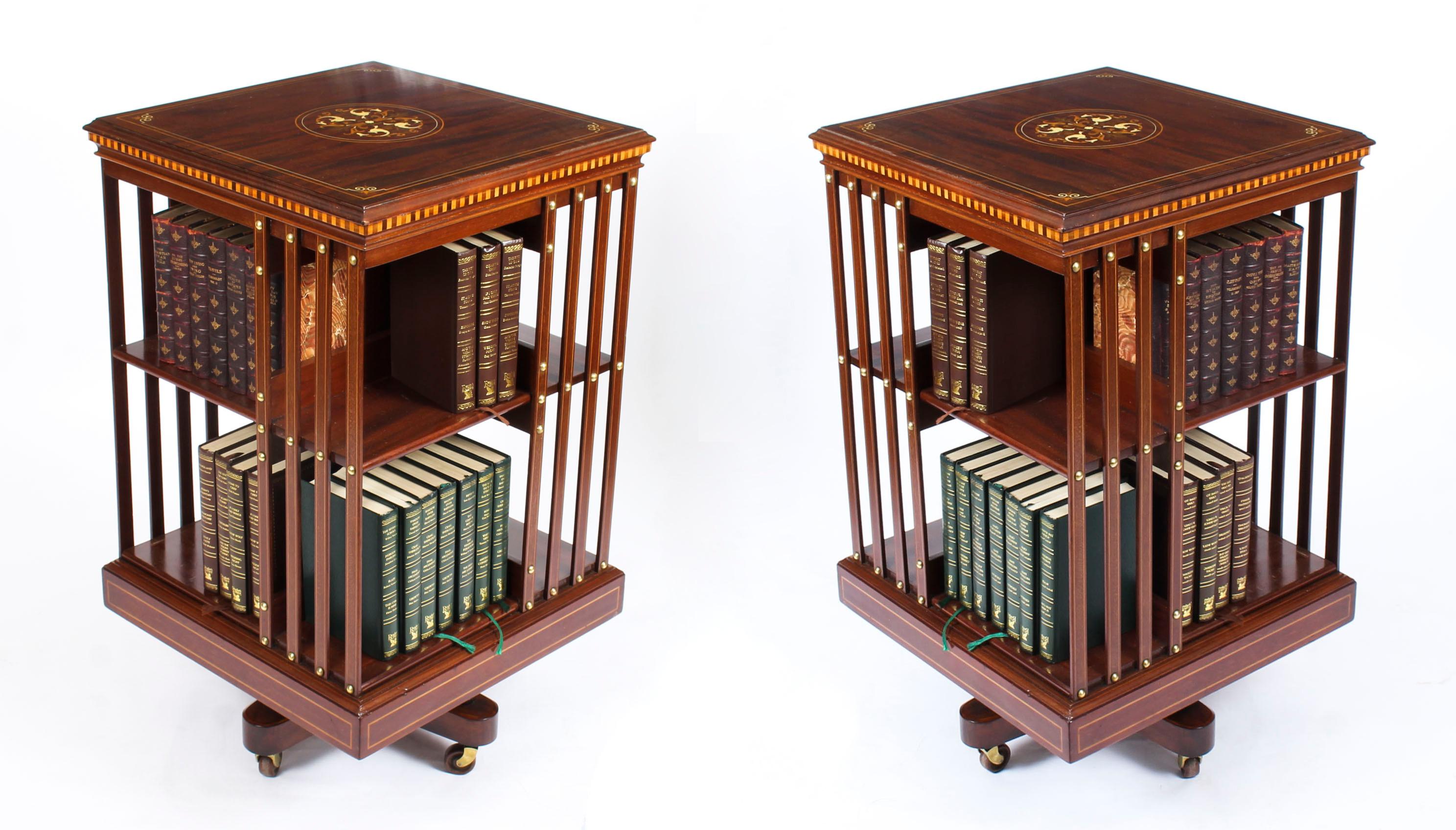 This is an exquisite pair of antique Edwardian marquetry inlaid flame mahogany revolving bookcases, circa 1890 in date.

These exquisite revolving bookcases are made of beautiful solid mahogany and the square tops have been masterfully inlaid with
