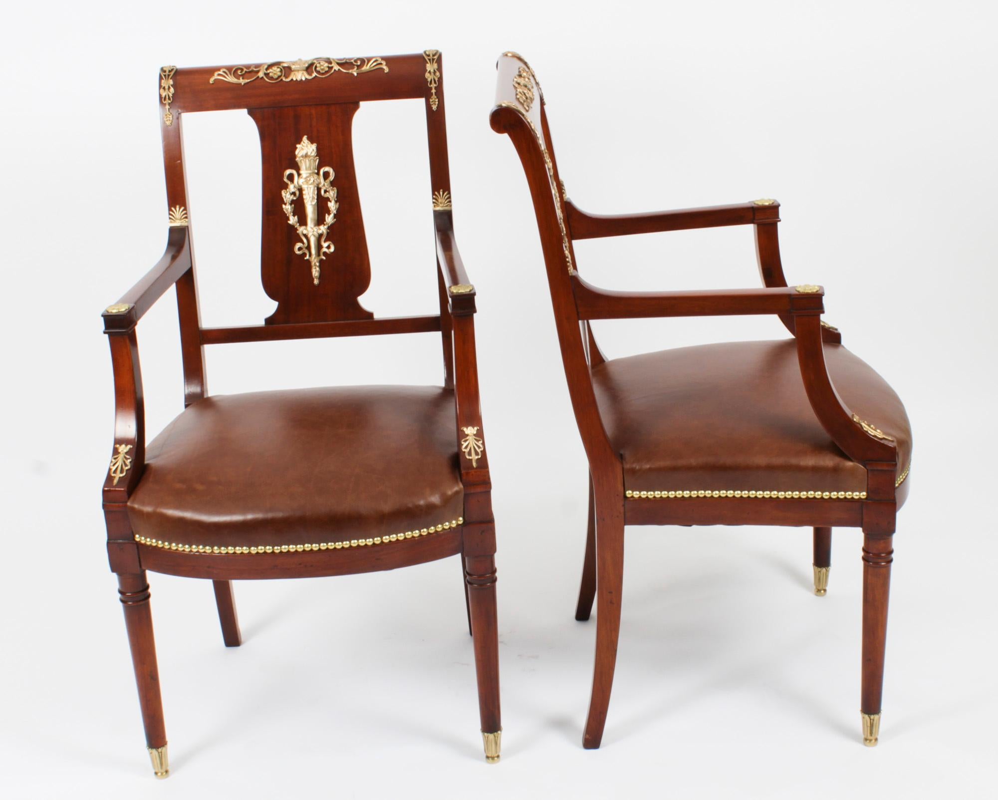 This is a fantastic and highly decorative antique pair of French gilt bronze mounted Empire Revival fauteuil armchairs, circa 1880 in date.

They have been crafted from fabulous solid mahogany and are smothered in fabulous high quality ormolu mounts