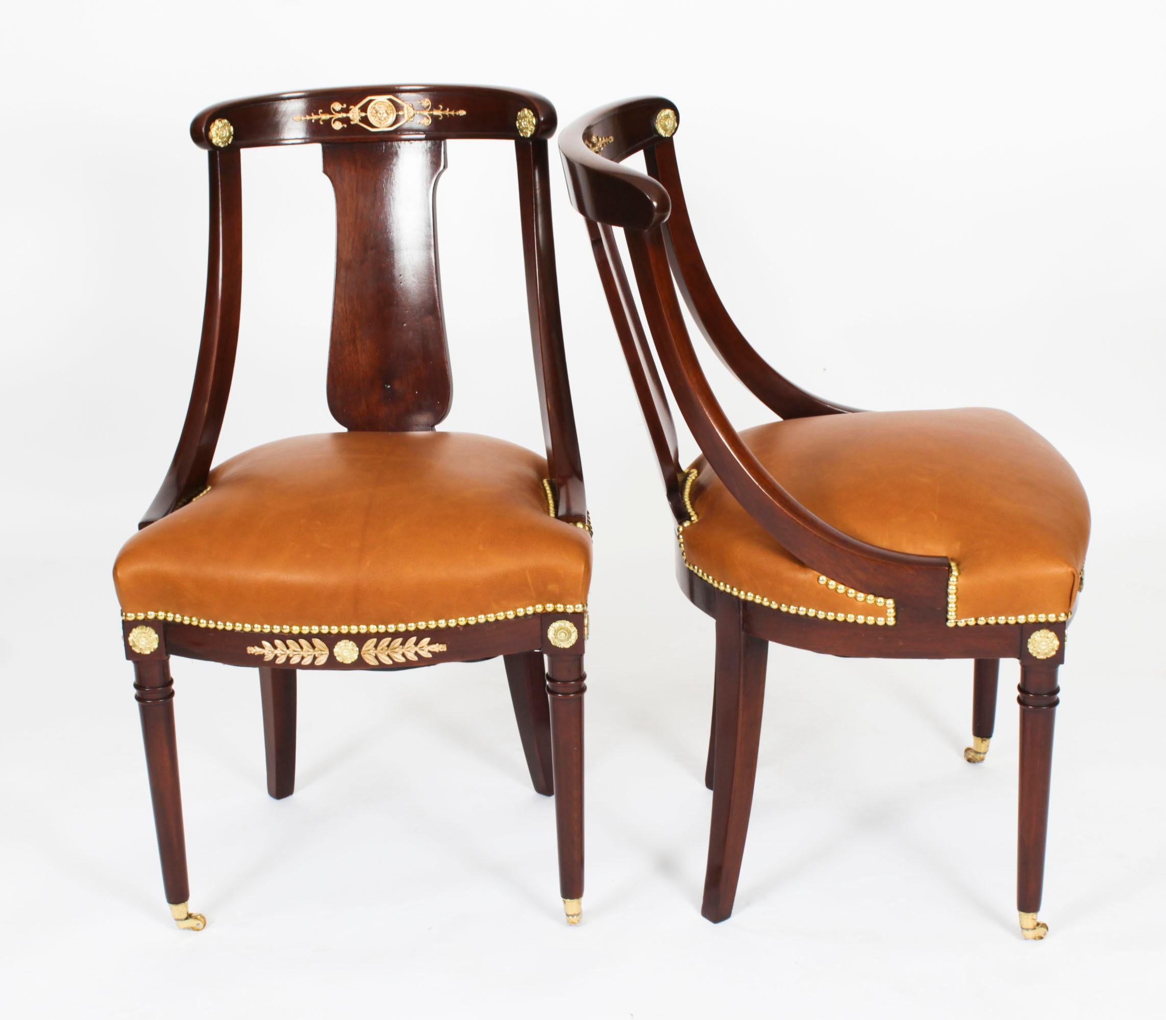 This is a fantastic and highly decorative antique pair of French gilt bronze mounted Empire Revival fauteuil chairs, circa 1880 in date.

They have been crafted from fabulous solid mahogany and are smothered in fabulous high quality ormolu mounts