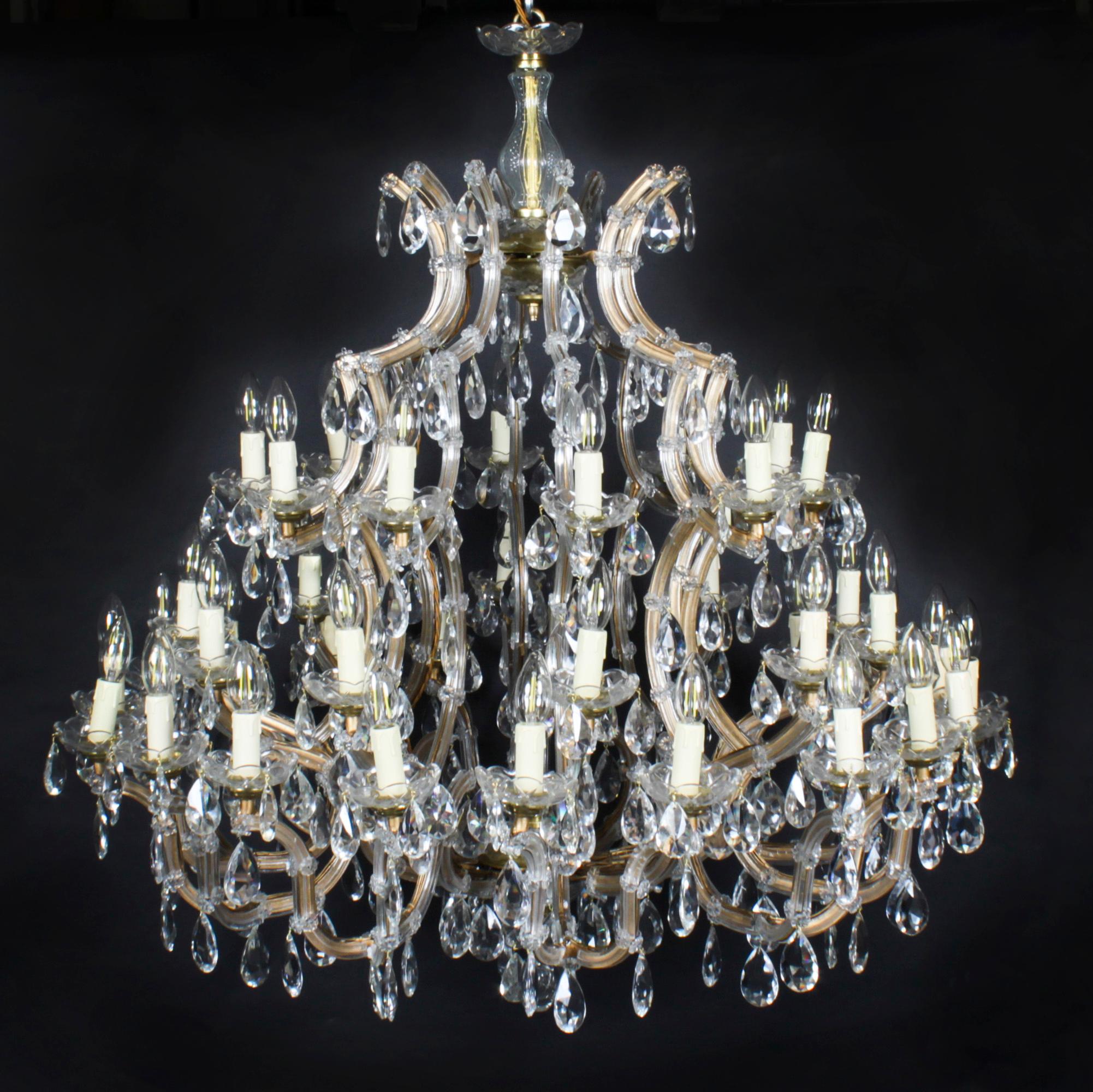 This is a beautiful pair of English Ballroom crystal chandeliers each with forty-one lights arranged over three tiers, and circa 1920 in date.

This magnificent pair of chandelier have exceptional crystal covered casting with an abundance of