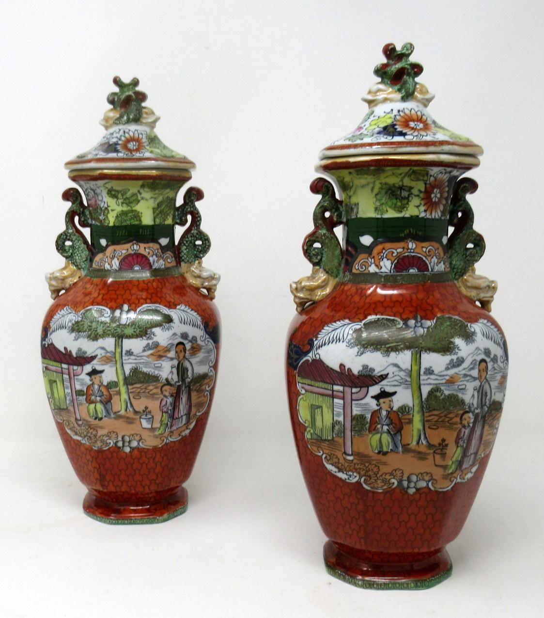 Stunning Example of a rare Pair of early English Chinoiserie Masons Ironstone China Lidded Vases hand painted in the “Conversation” pattern depicting vignettes of Chinese Figures in a garden setting. Octagonal Baluster form throughout. Mid
