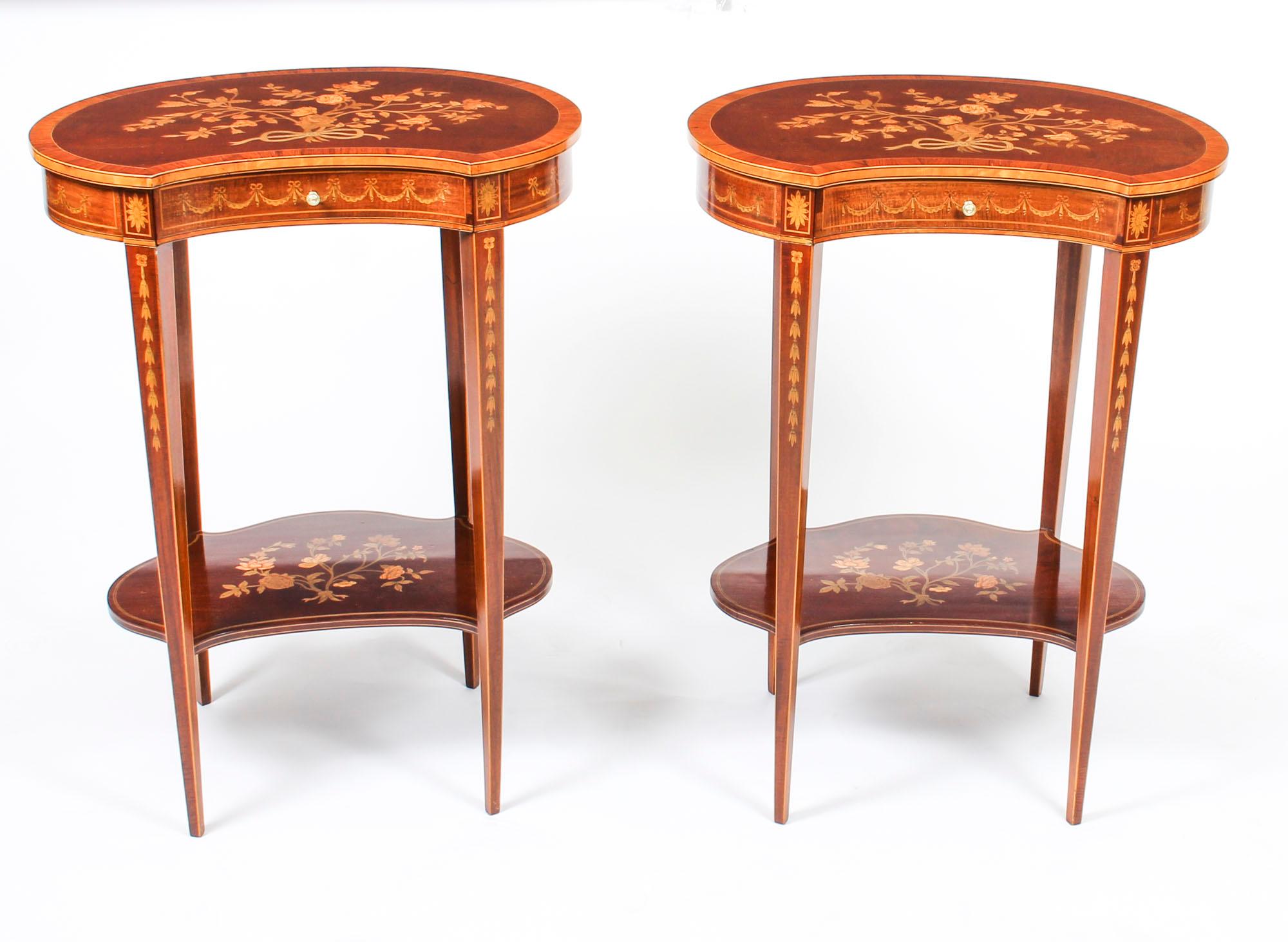 This is a gorgeous pair of antique English kidney shaped mahogany marquetry inlaid occasional tables, circa 1880 in date.

The tables each have crossbanded tops beautifully inlaid with ribbons tied flowers, the friezes with inlaid swags and with