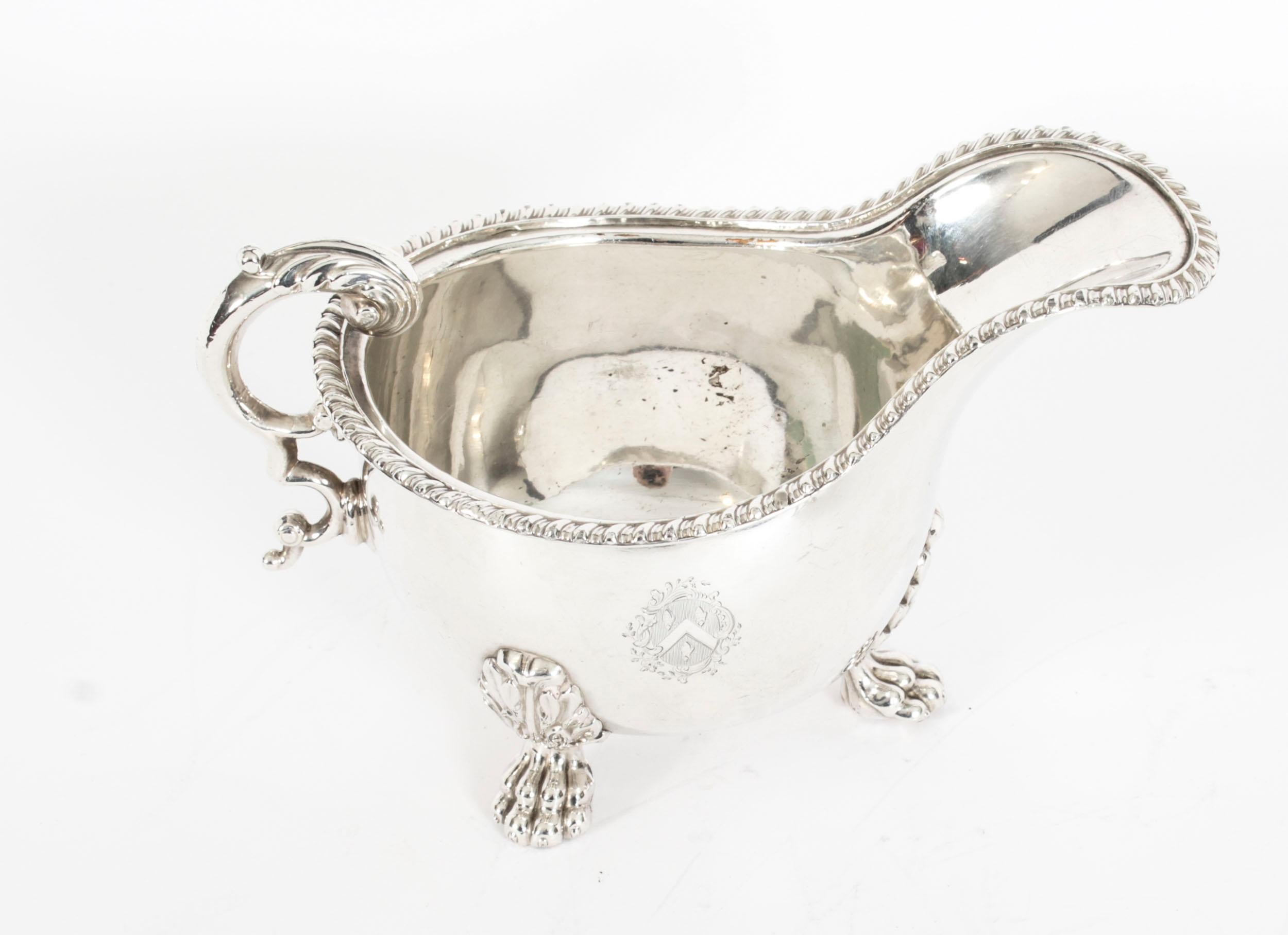 This is a elegant pair of Old Sheffield silver plated sauce boats, circa 1830 in date.
 
The sauce boats feature oval shape bodys with beautiful gadrooned borders, each with an engraved central coat of arms and classical handles with chased