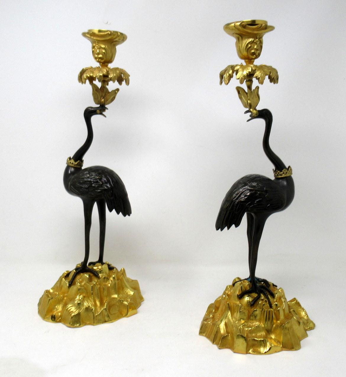 Stunning pair of English ormolu and patinated bronze single light candlesticks of good size proportions modelled as a pair of storks, signed Abbott, circa 1840.

Each exquisitely modelled as standing storks or cranes perched on a gilt naturalistic