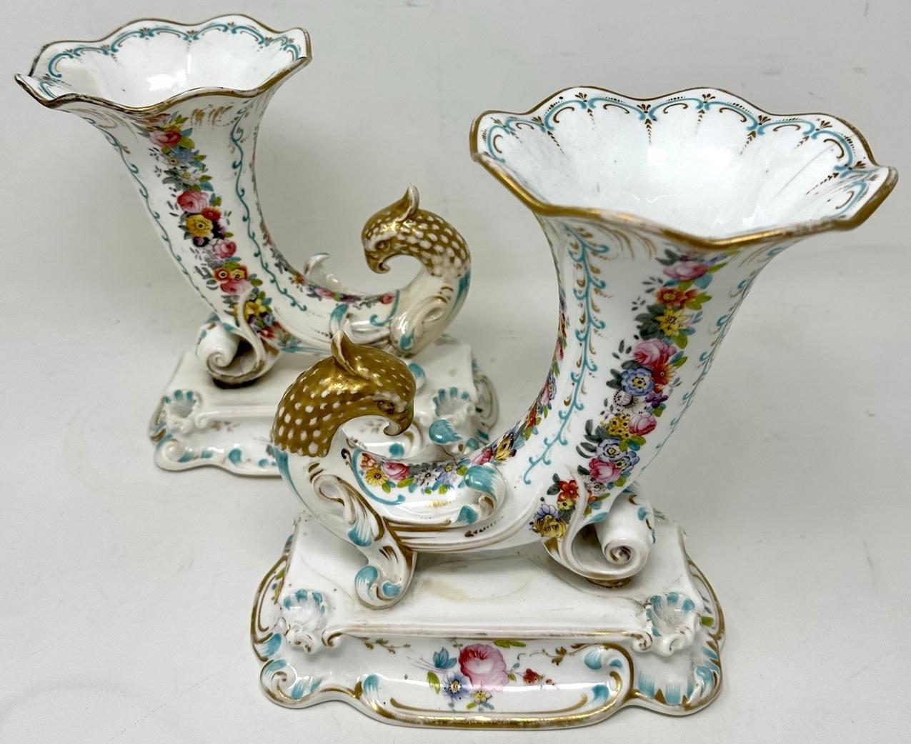 Stunning example of an English Hand Decorated Porcelain Flair Rim Vases of museum quality, unmarked but firmly attributed to Rockingham. Last half of the Nineteenth Century.  

Each delicate wavy rim horn of plenty superbly hand painted depicting