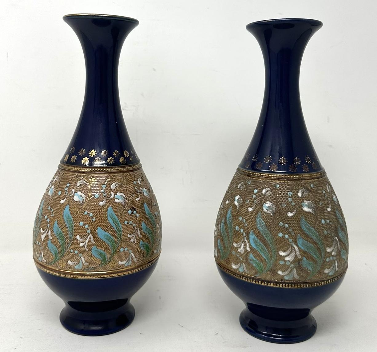A Very Stylish Identical Pair of English Royal Doulton Slaters Moulded Salt-Glaze Stoneware Pottery Long neck mantle Vases of generous proportions. 

Each of bulbous form with flaired flat formed rims. Lavish Art Nouveau raised slaters pattern