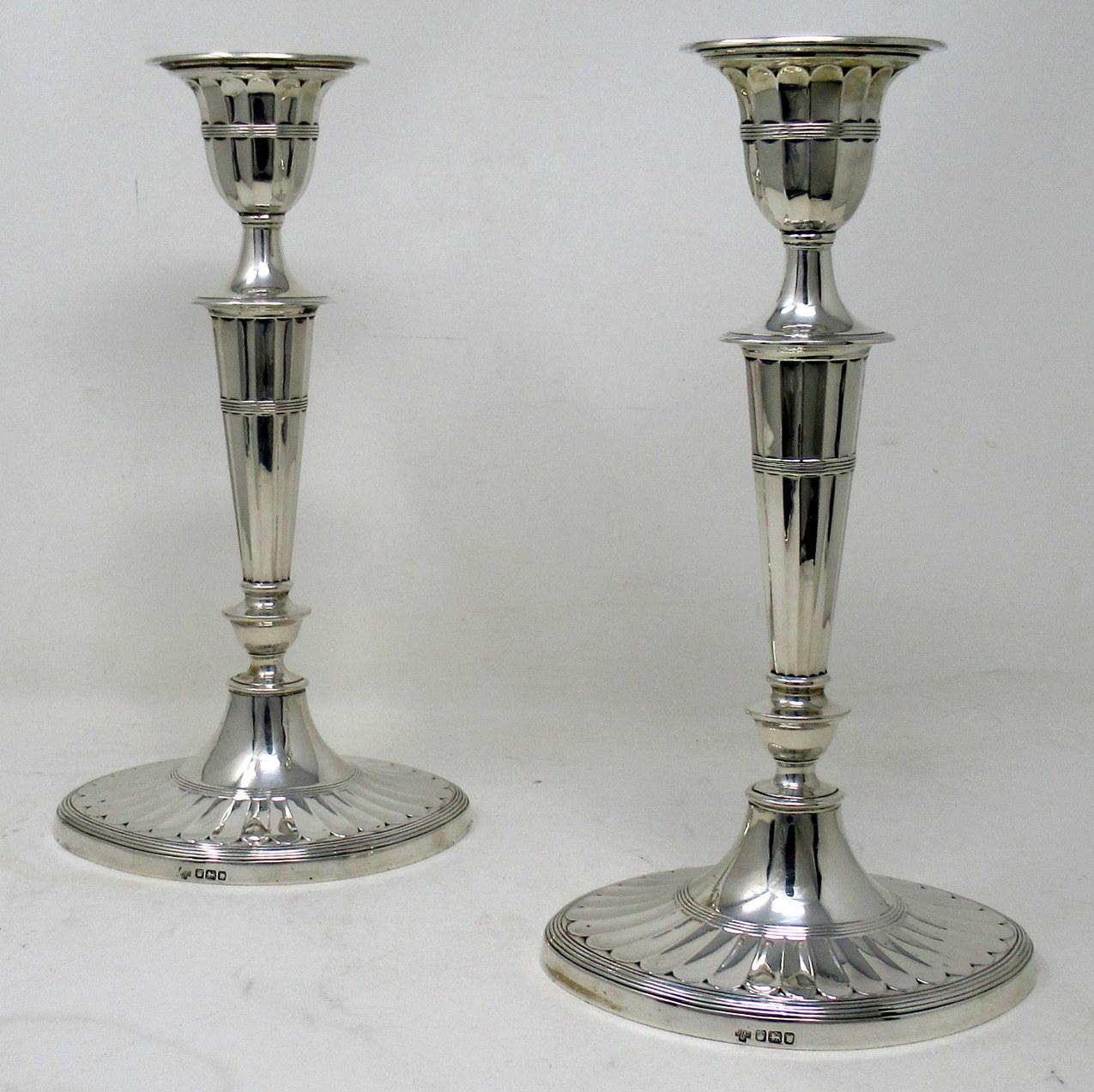 Stylish Pair of early Edwardian English Adams Style heavy gauge Sterling Silver Single Light Table Candlesticks of outstanding quality and quite large proportions.  

Mark of Hawksworth Eyre & Company. Rockingham Street, Sheffield 

Sheffield