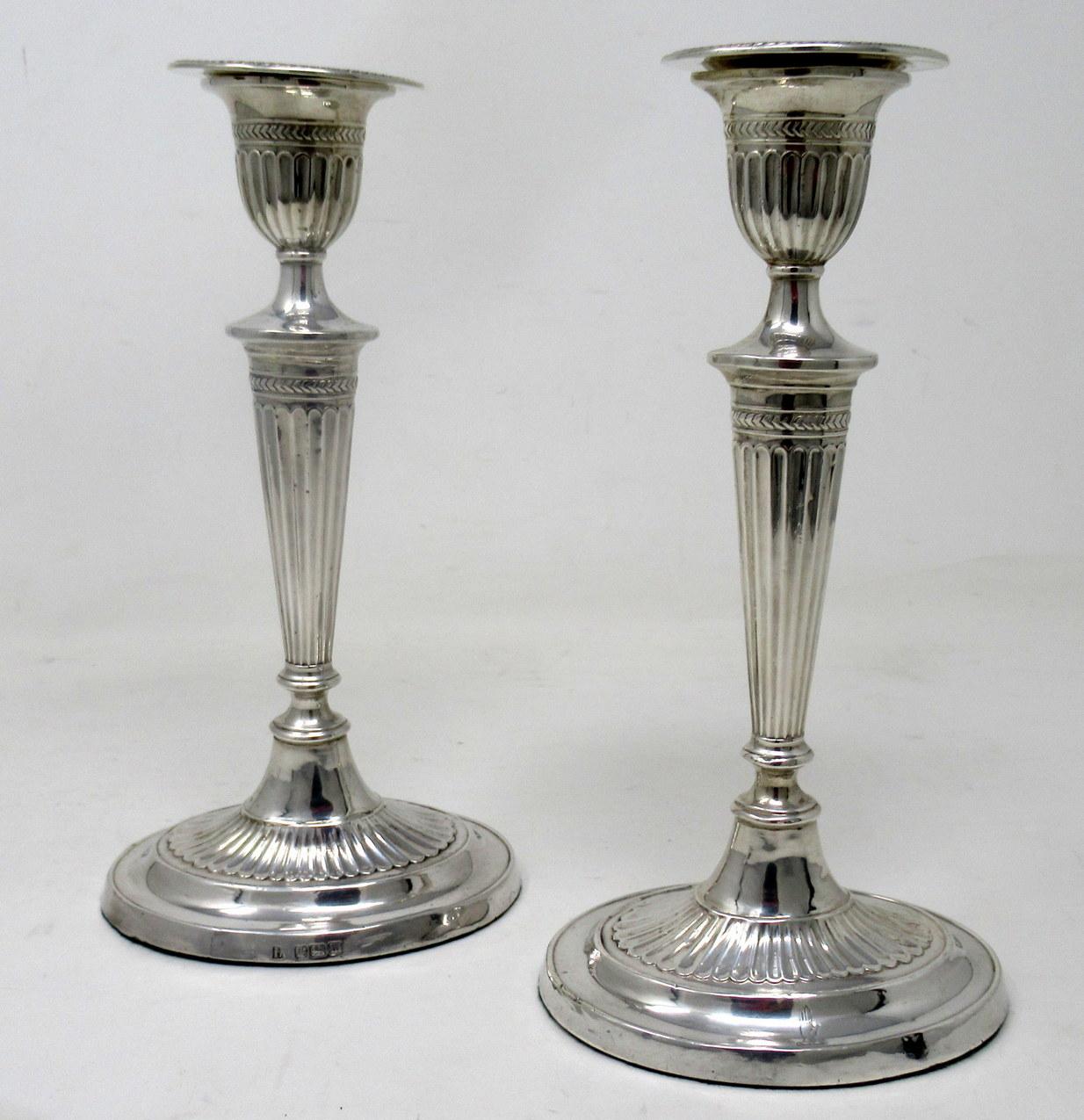 Stylish Pair of early Edwardian English Adams Style heavy gauge Sterling Silver Single Light Table Candlesticks of outstanding quality and compact proportions. 

Mark of Fordham & Faulkner. Orchard Works, Sheffield 

Sheffield Hallmark for 1905.