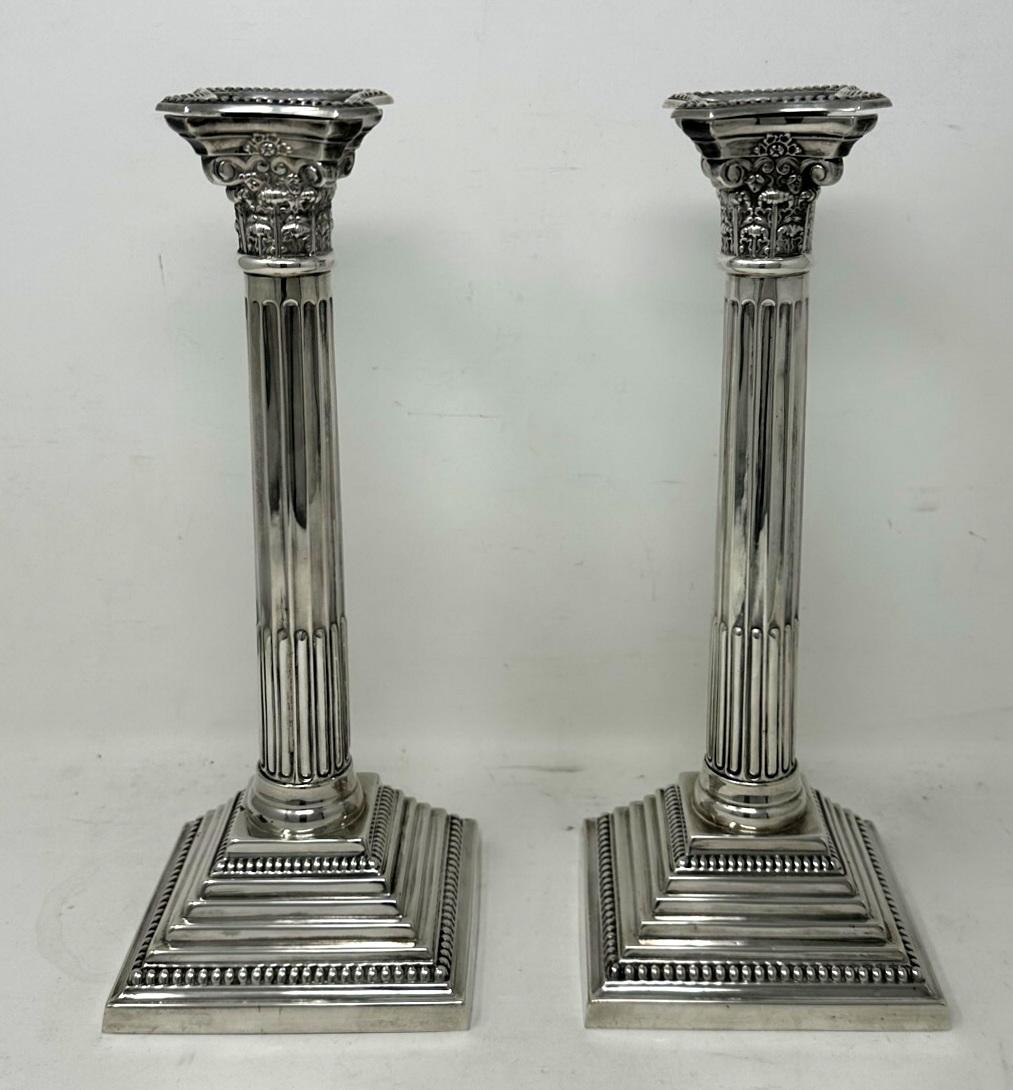 Stylish Pair of Mid-Century English Traditional Corinthian Column Pillar heavy gauge Sterling Silver Single Light Table Candlesticks of nice tall and generous proportions.  

Mark of A T & S for A Taite & Sons. Greatorex Street and Whitechapel