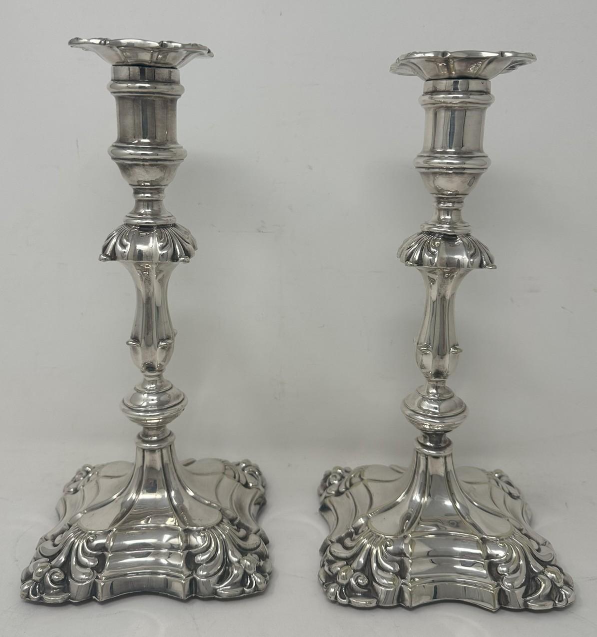 Beautiful and stylish high-quality pair of antique silverplated heavy gauge candlesticks made in the George III style with square ribbed tapering columns, annulated knops and raised stepped square petaled and weighted bases, firmly attributed to
