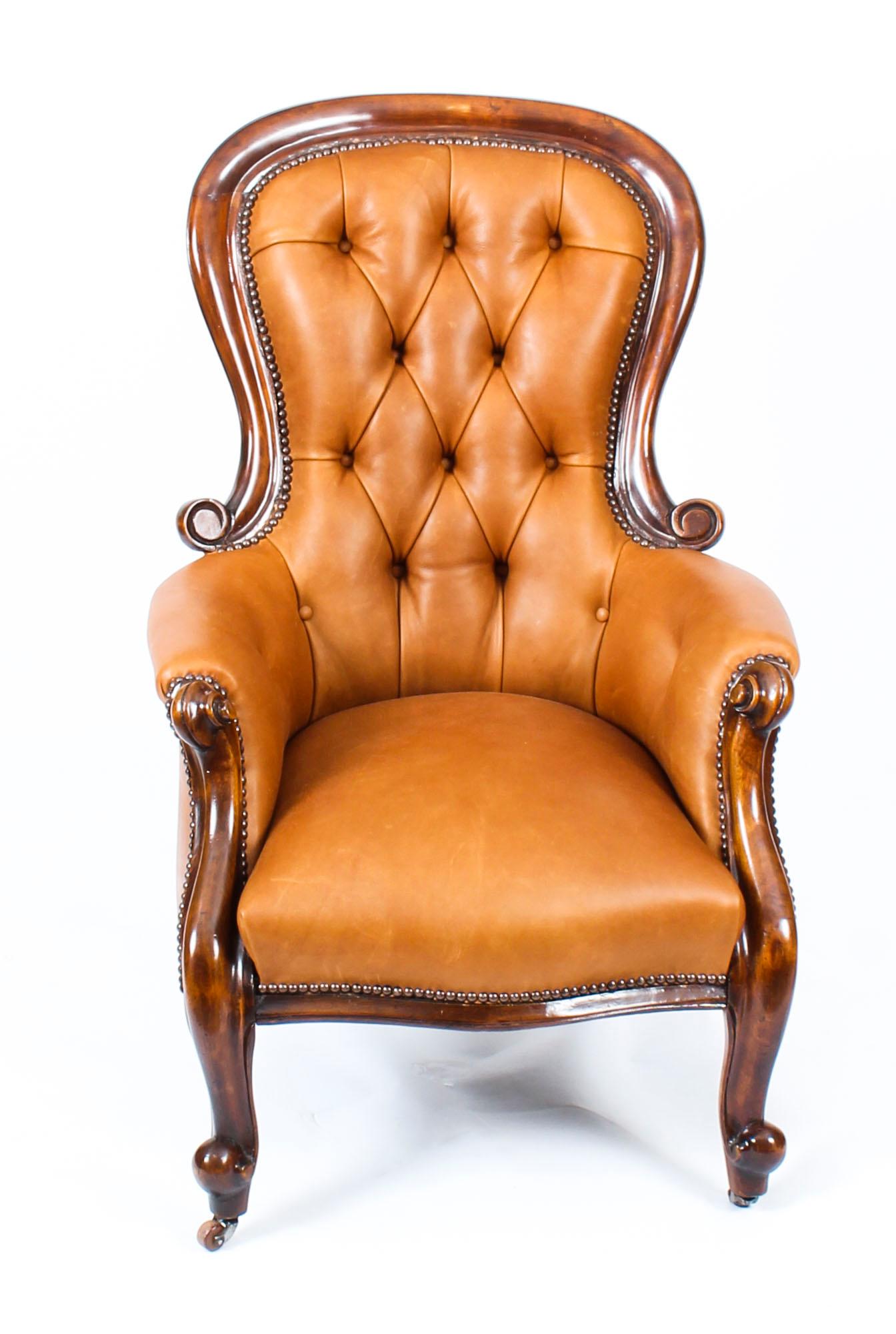 This is a handsome pair of antique Victorian mahogany and leather upholstered spoonback armchairs, circa 1870 in date.

This pair was made from hand carved solid mahogany, each with button backed leather upholstery in a beautiful tan color. They are
