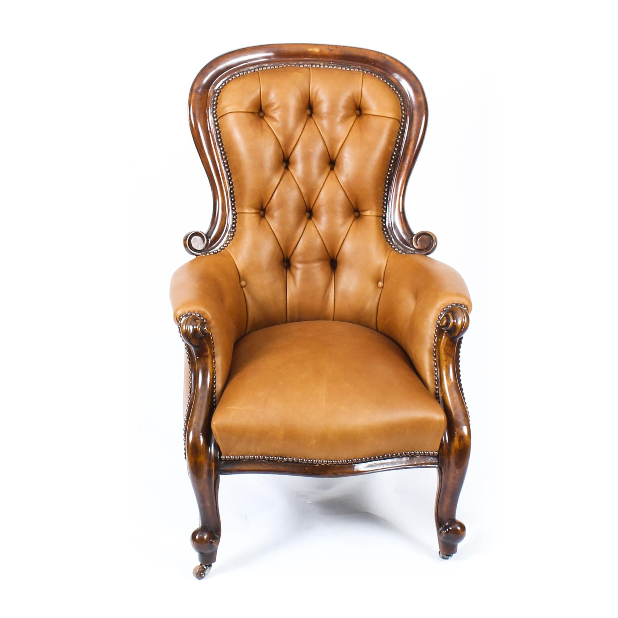This is a handsome pair of antique Victorian mahogany and leather upholstered spoonback armchairs, circa 1870 in date.
 
This pair was made from hand carved solid mahogany, each with button backed leather upholstery in a beautiful tan colour. They