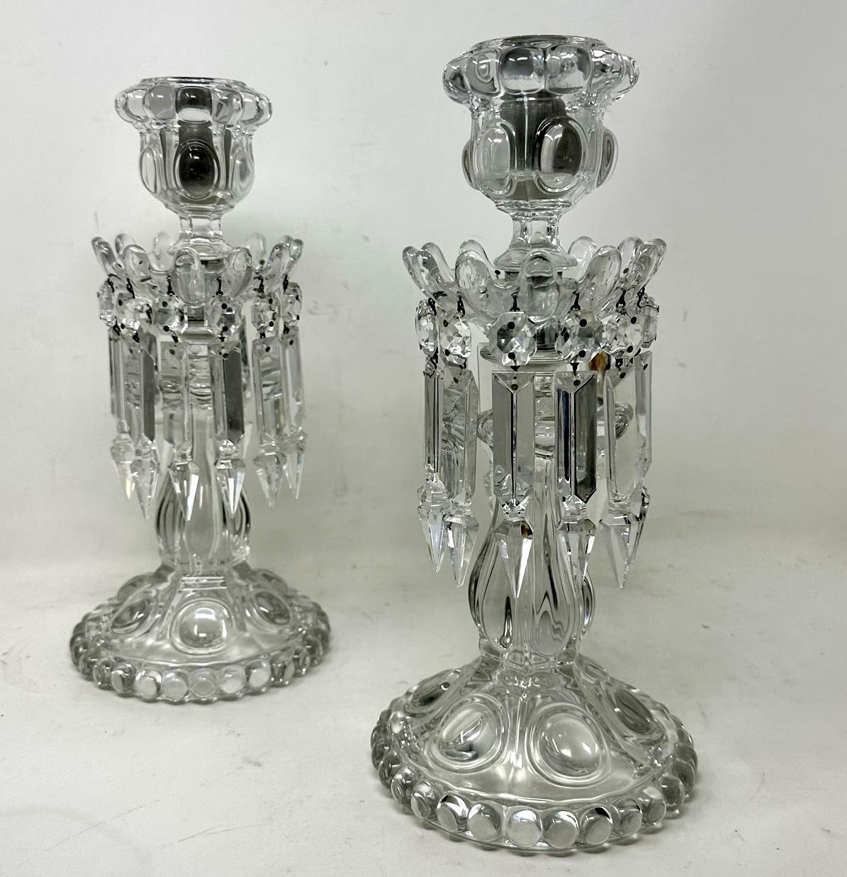 An Exceptionally Fine Example of a French Baccarat Pair of Regency Style Neoclassical Single Light Full Lead Hand Cut Candlesticks Lustres of generous proportions with stylish bulbous columns above dome shaped circular spreading bases with