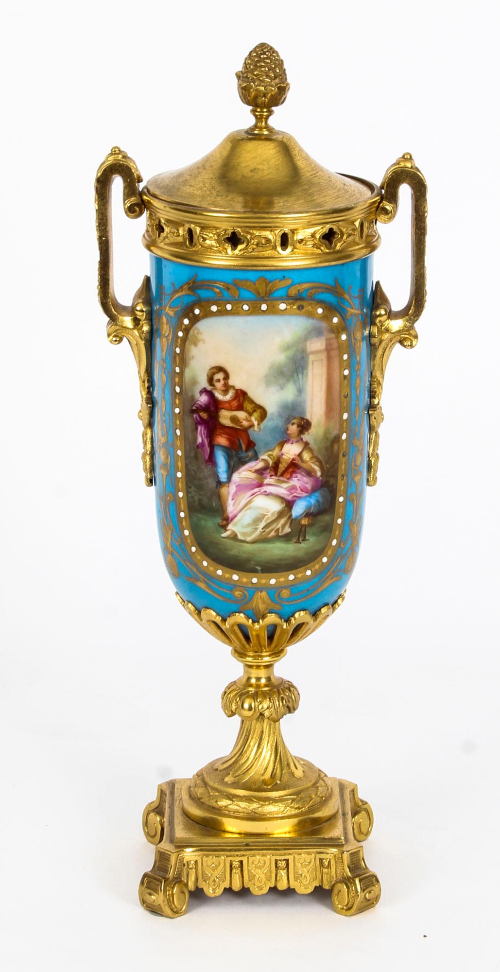 This is a beautiful antique pair of French Sevres porcelain and ormolu-mounted lidded vases, in the Louis XV manner, circa 1870 in date.

They are superbly decorated in a wonderful Bleu Celeste color with hand painted panels of courting couples