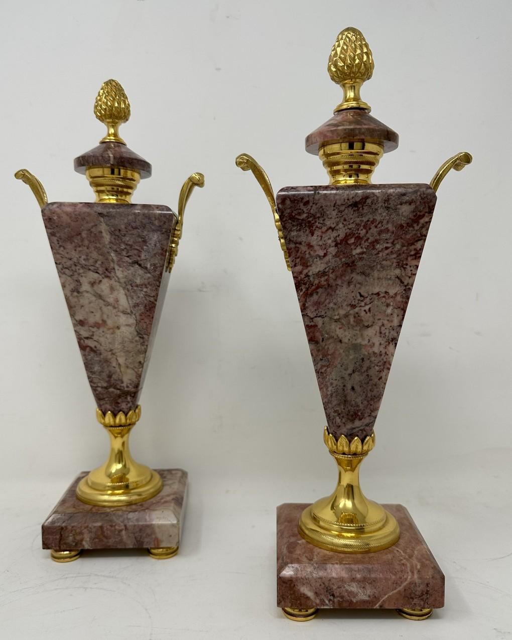 Stunning Pair of French Ormolu and well figured Breche Violet Marble Twin Arm Decorative Sidepieces of generous proportions, modelled in the Art Deco Style but possibly made earlier. 

The unusual triangular formed main supports below an ornate