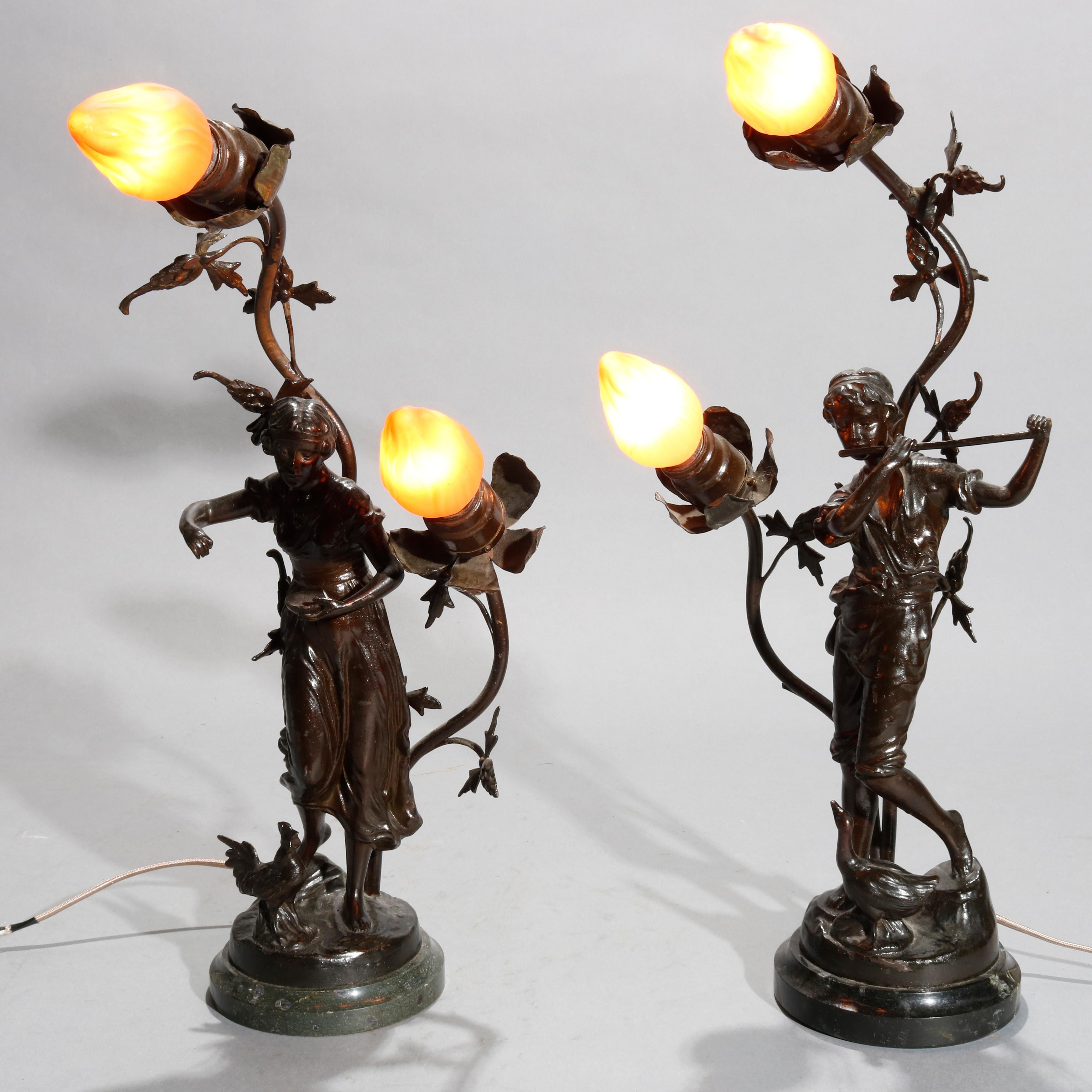 An antique pair of French figurative Newel post lamps offer bronzed metal construction with dancing muses beneath foliate form arms terminating in floral form lights, circa 1900
Antique pair of French bronzed metal figural Newel post lamps, circa
