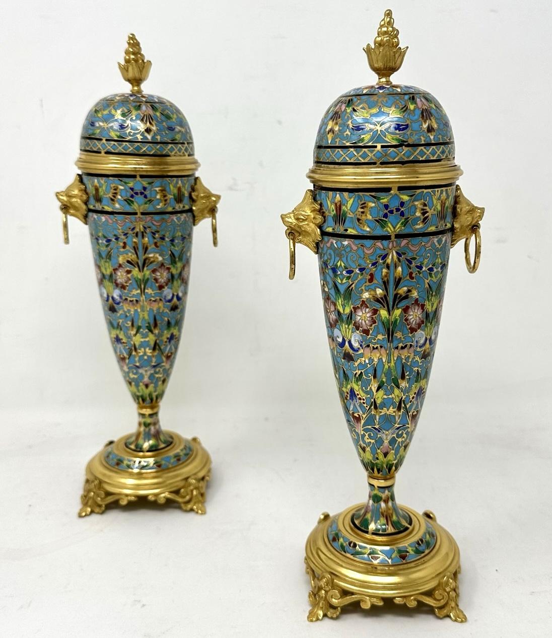 An Exceptionally Stylish Pair of French Bronze Dore and Champleve Cloisonne dome lidded Vases of outstanding quality. Third quarter of the Nineteenth Century. 

This magnificent pair of Vases are wrought from Gilt Ormolu and Champleve enamel in the