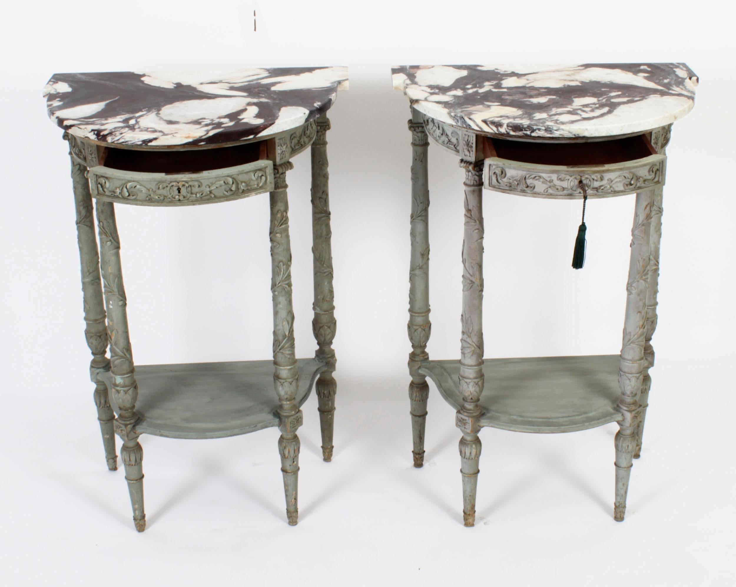 This is a superb pair of antique French painted demi-lune console tables by Bettenfeld of Paris, circa 1870 in date.
 
Each console has a beautiful 'D' end shaped scalloped grey marble top, the frieze is decorated with carved acanthus leaves and