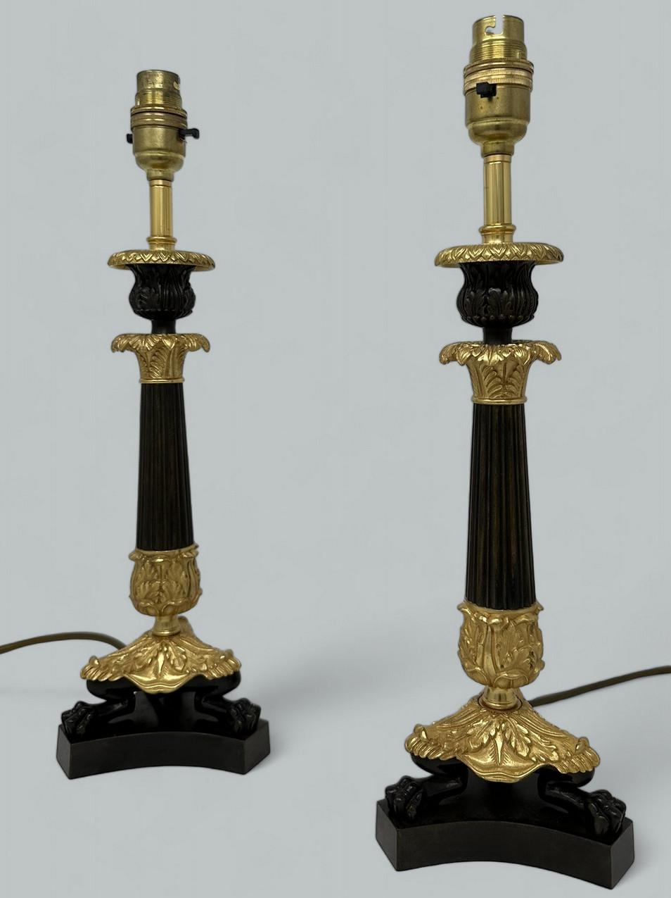 Stunning Identical Pair French Heavy Gauge Ormolu and Bronze Single Light Candlesticks of average size proportions, now converted to a Pair of Electric Table Lamps, with tapering reeded central bronze column, each ending with three very ornate