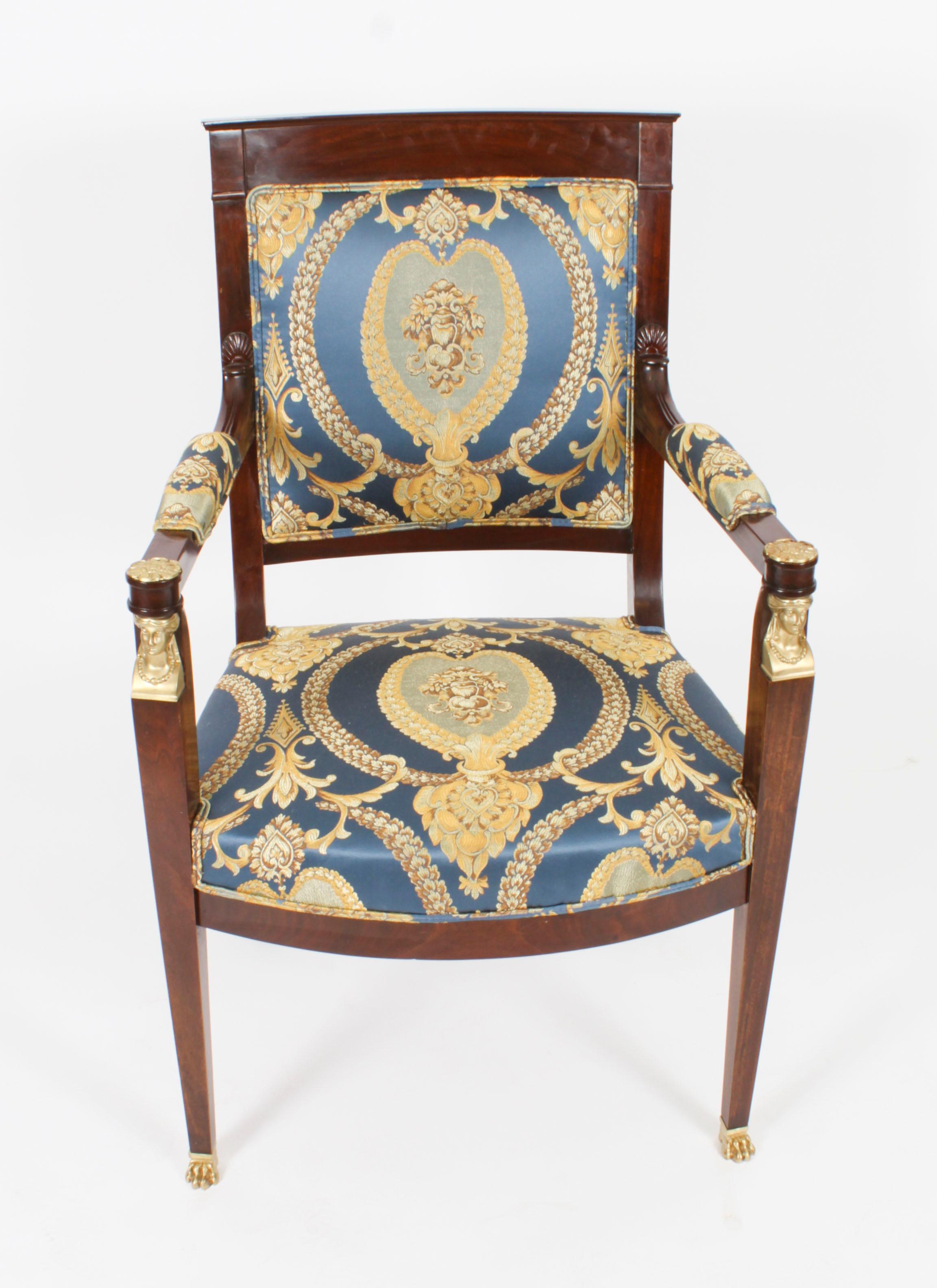 This is a fantastic and highly decorative antique pair of French gilt bronze mounted Empire Revival fauteuil armchairs,  circa 1870 in date.

They have been crafted from fabulous solid mahogany and are smothered in fabulous high quality ormolu