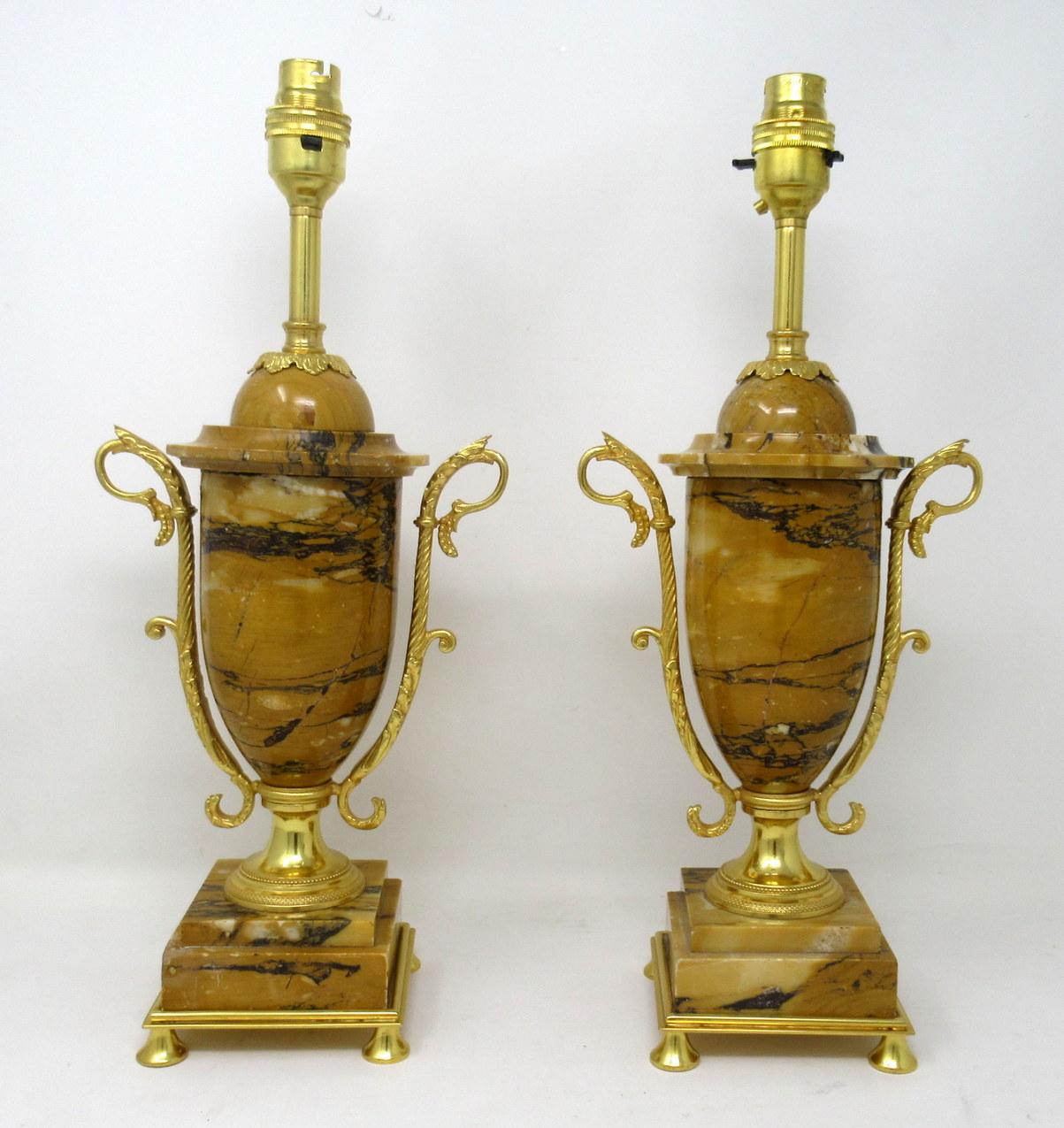 Stunning pair of French well veined sienna marble and ormolu twin handle urns of exceptional quality, now converted to electric table lamps of medium proportions,

Each of ovoid outline with applied nicely cast ormolu mounts and twin decorative