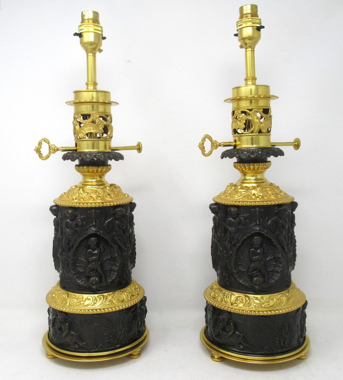 An exceptionally fine pair French finely cast patinated dark brown bronze fluid oil table lamps of generous proportions, depicting Neoclassical scenes of cherubs with scrolling details and stylish beaded rims, now converted to electricity.

The