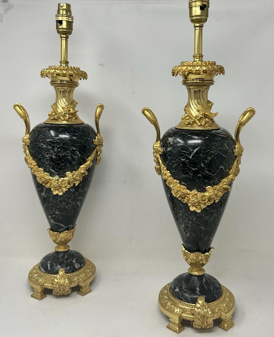 An Exceptionally Fine Pair of heavy gauge French Verde Antico Marble and Ormolu Mounted Urns, now converted to a Pair of Electric Table Lamps of generous proportions, mid to late Nineteenth Century. 

The main oviform bodies with central chisel