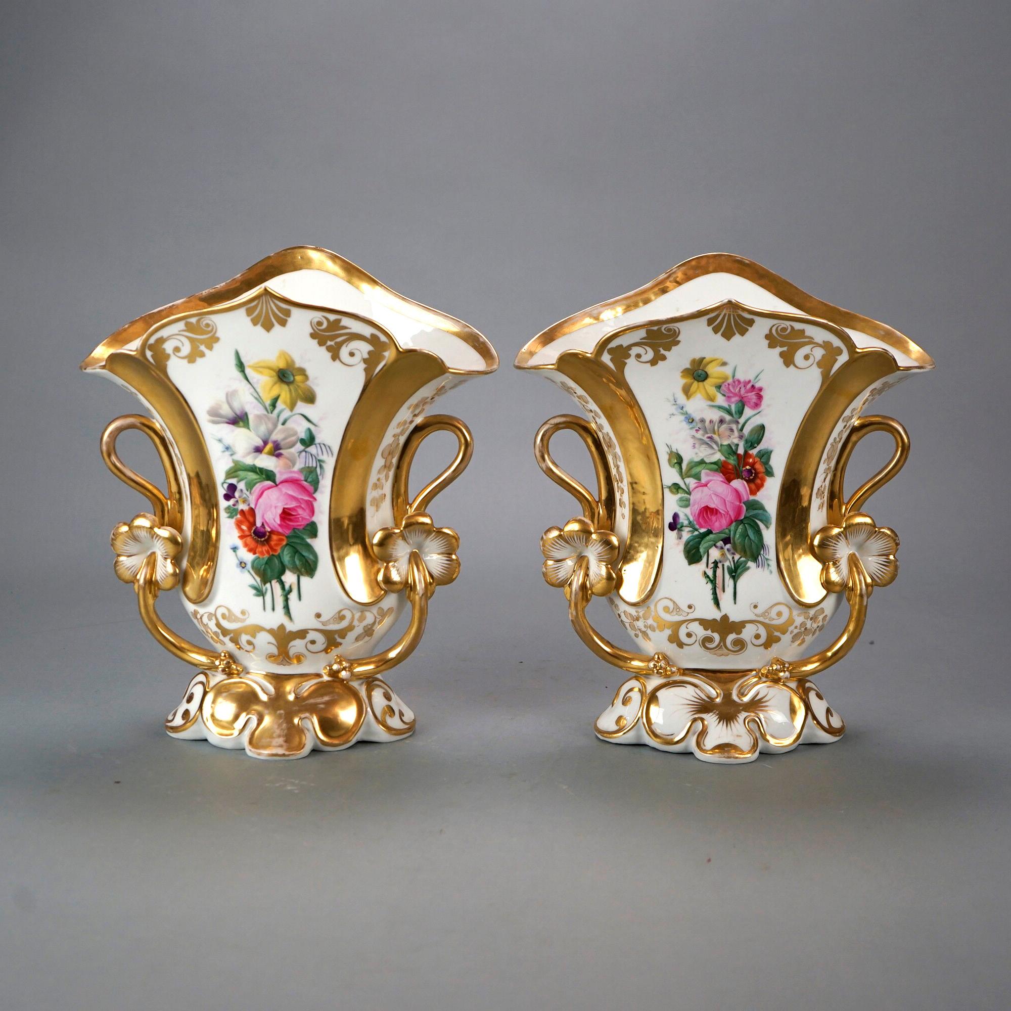 A pair of antique French Old Paris spill vases offer porcelain footed construction with hand painted floral decoration and gilt highlights throughout, 19th century

Measures- 12'' H x 10.5'' W x 6.25'' D.