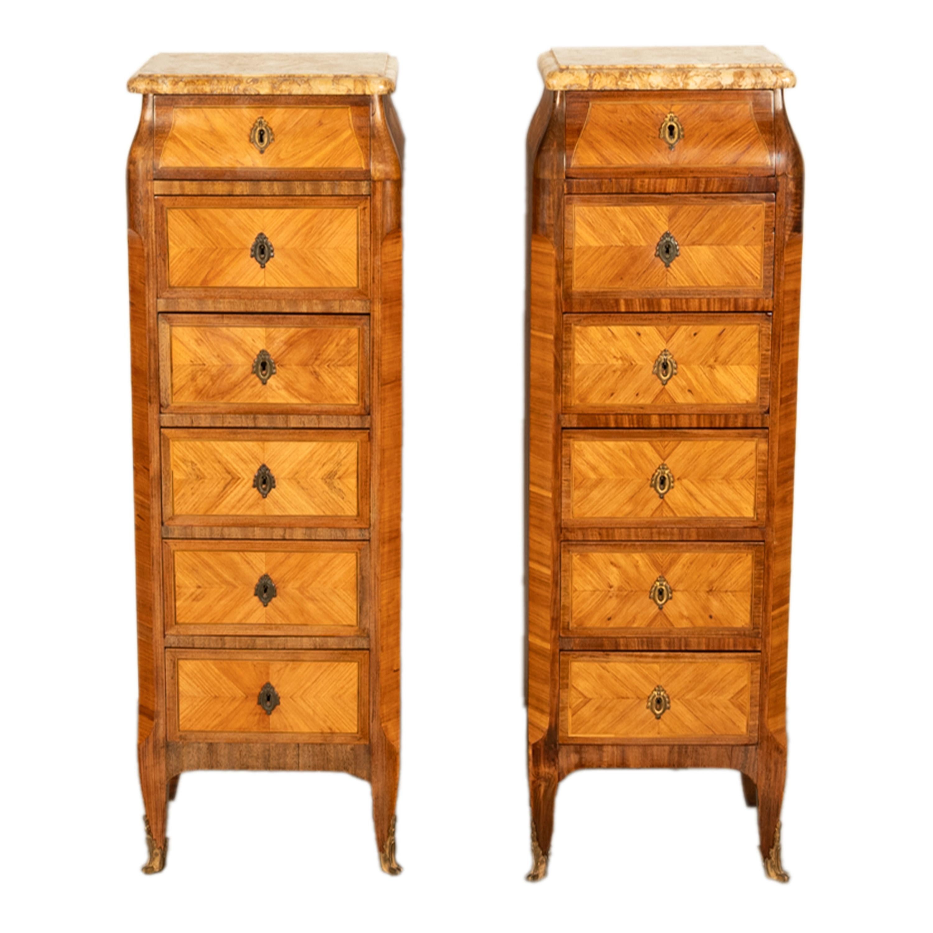 A fine Pair of antique 19th century French, Louis XV 'Semainiers', tall Lingerie marble topped commodes, circa 1880.
Each chest having a varigated 'caramel' colored marble top with a tapered top and six drawers below. Made from feather banded and