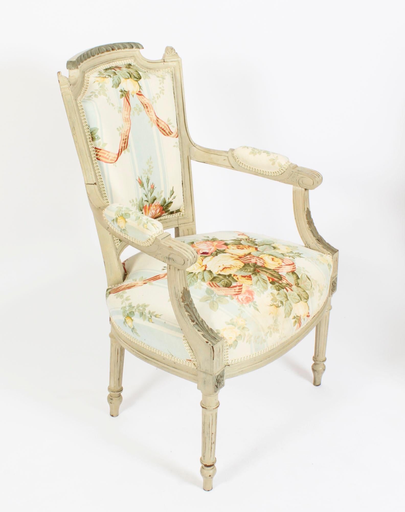This is a elegant Antique pair of Louis XVI Revival painted fauteuil armchairs, circa 1880 in date.
Constructed in a well carved two tone grey beechwood, with later floral and swag design upholstery; rising from turned and tapering legs with toupie