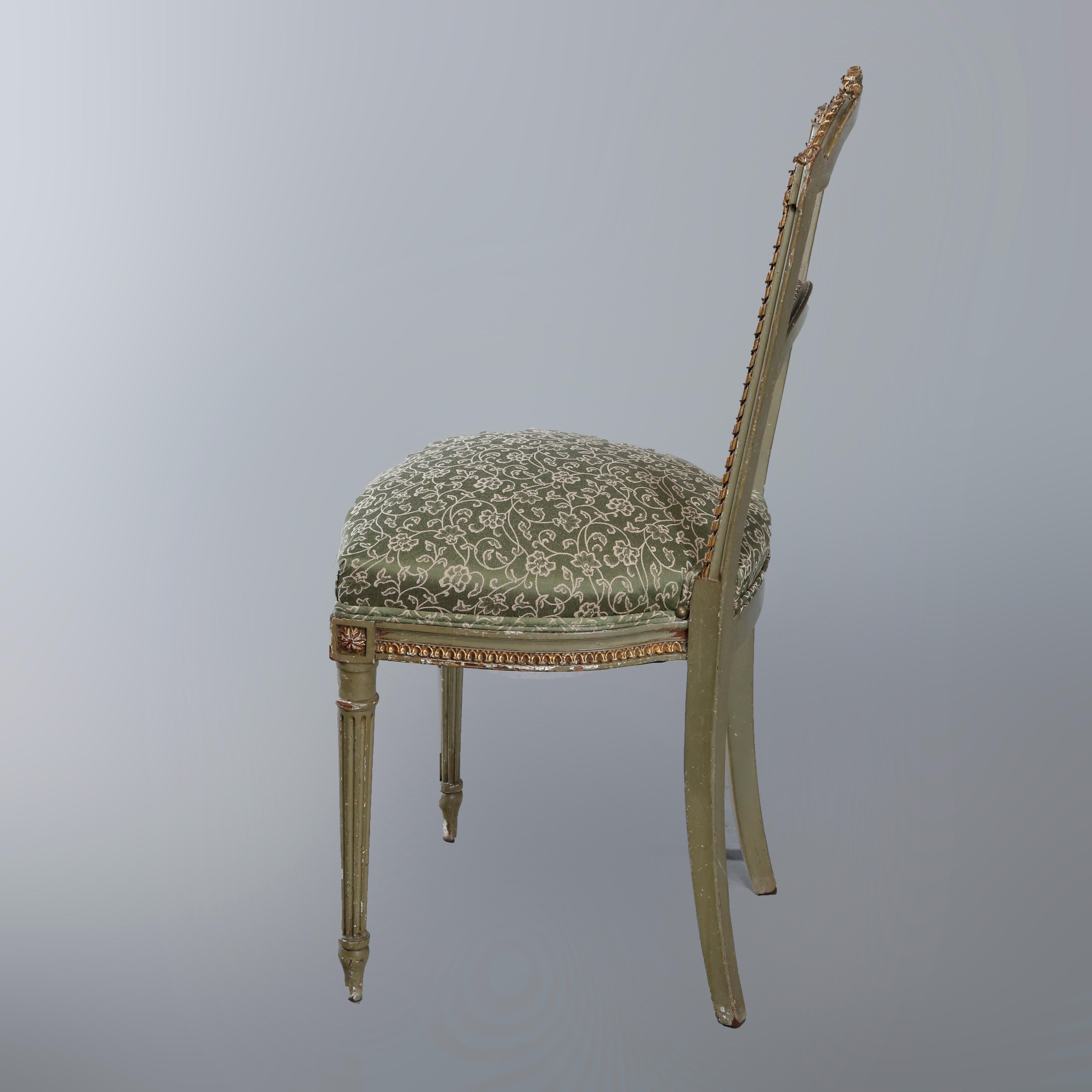 An antique pair of French Louis XVI side chairs offer parcel gilt painted wood frames having open stylized ladder backs with pierced carved floral crest surmounting frame with beaded and rope twist bordering over upholstered seat raised on turned