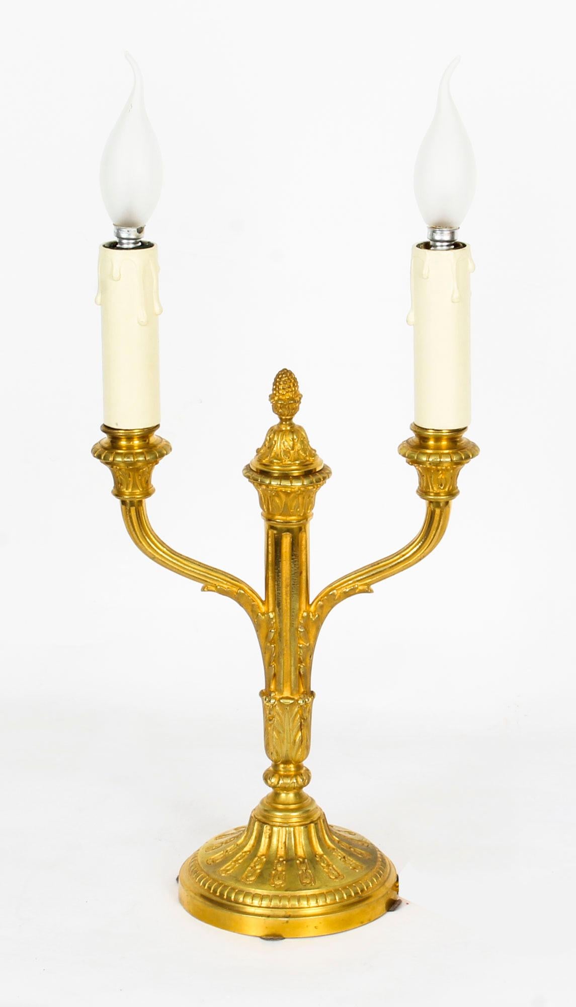 A fine antique pair of French neoclassical Ormolu candelabra, circa 1840 in date, later converted to table lamps.

This wonderful pair of doré bronze candelabras have decorative centre acorn finials surrounded by two arms decorated with acanthus