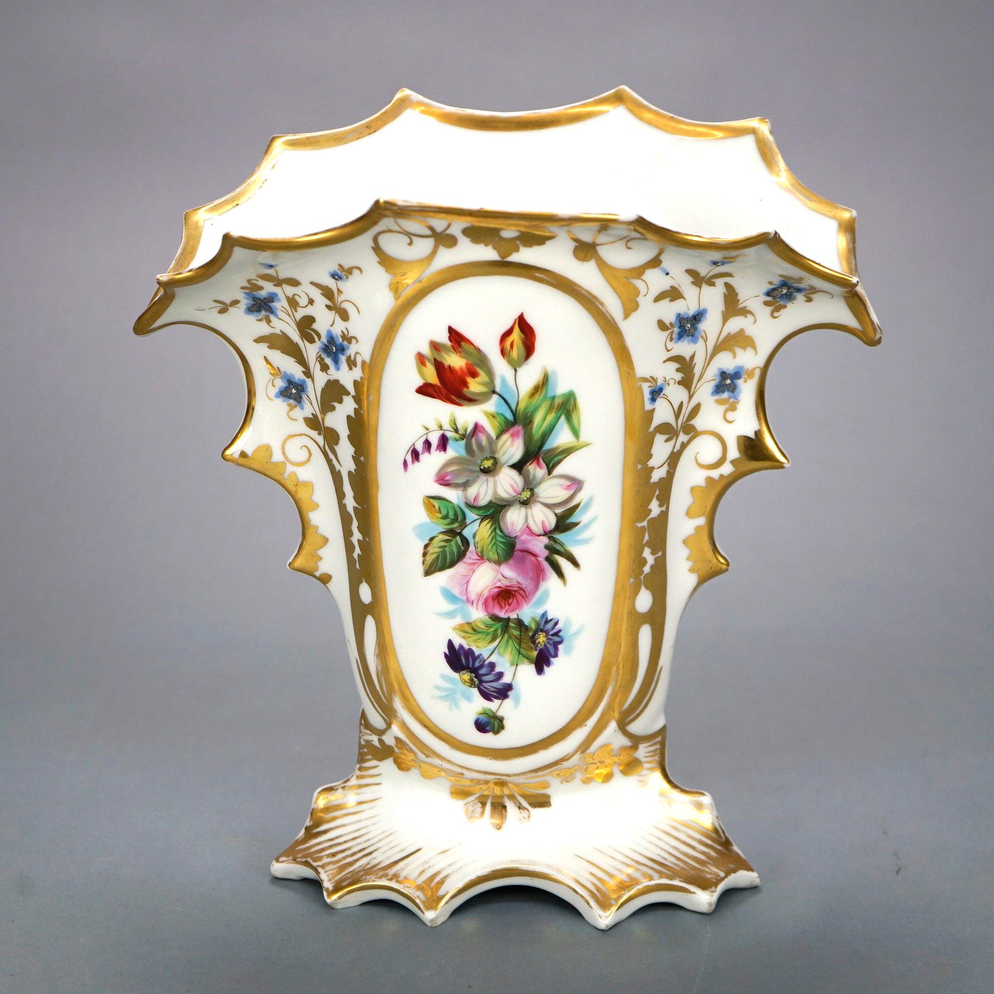 An antique pair of French Old Paris vases offer porcelain footed construction with scalloped rim, hand-painted floral decoration, and gilt highlights throughout, 19th century

Measures- 11'' H x 10.5'' W x 6'' D.