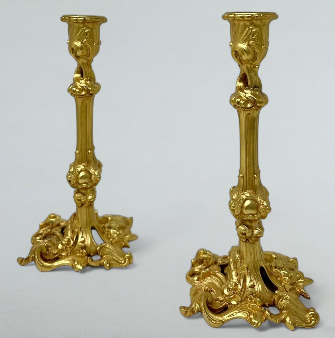 Stylish Pair of early Edwardian French heavy gauge Ormolu Single Light Table Candlesticks of outstanding quality and generous proportions.  

Each with shaped spreading bases with highly chisel cast shell and scrolling cast corners details, the