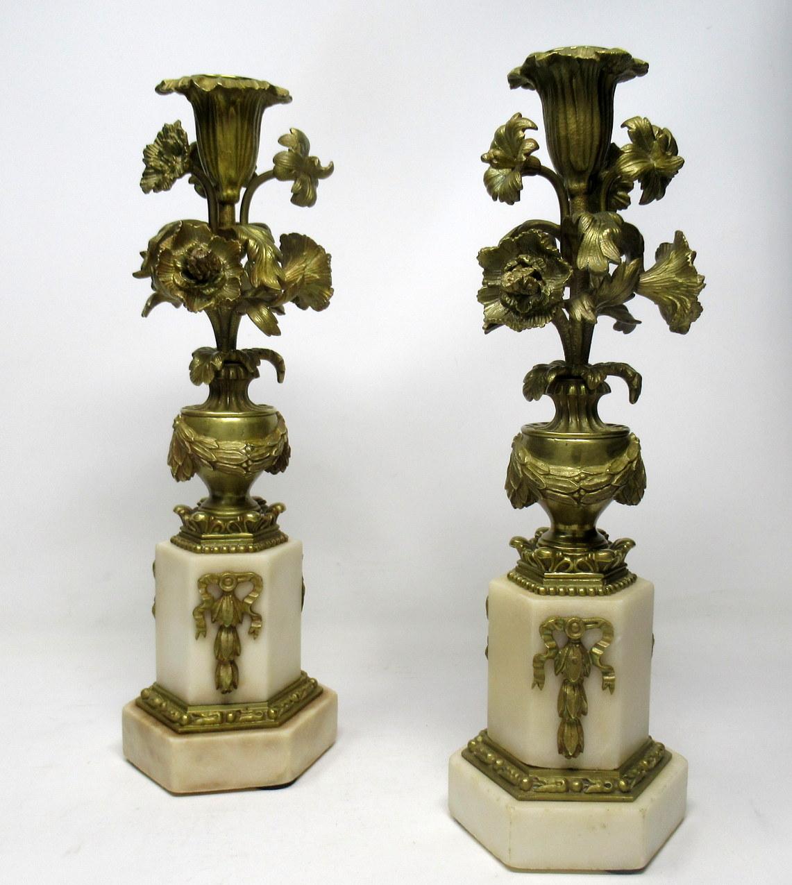 A very impressive example of a pair of single light statutory cream marble and ormolu candlesticks of outstanding quality and medium proportions.

Last half of the 19th century. 

The elaborate upward scrolling naturalistic central support