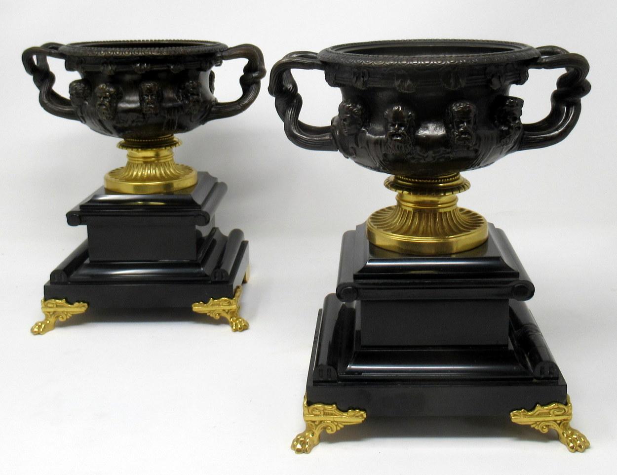 Superb example of a pair of French Ormolu and bronze cast model of the Warwick Albani Vase, circa 1860. Mounted on heavy square black marble stepped bases, each supported by a pair of very stylish ormolu claw feet.

After the antique, each vase on