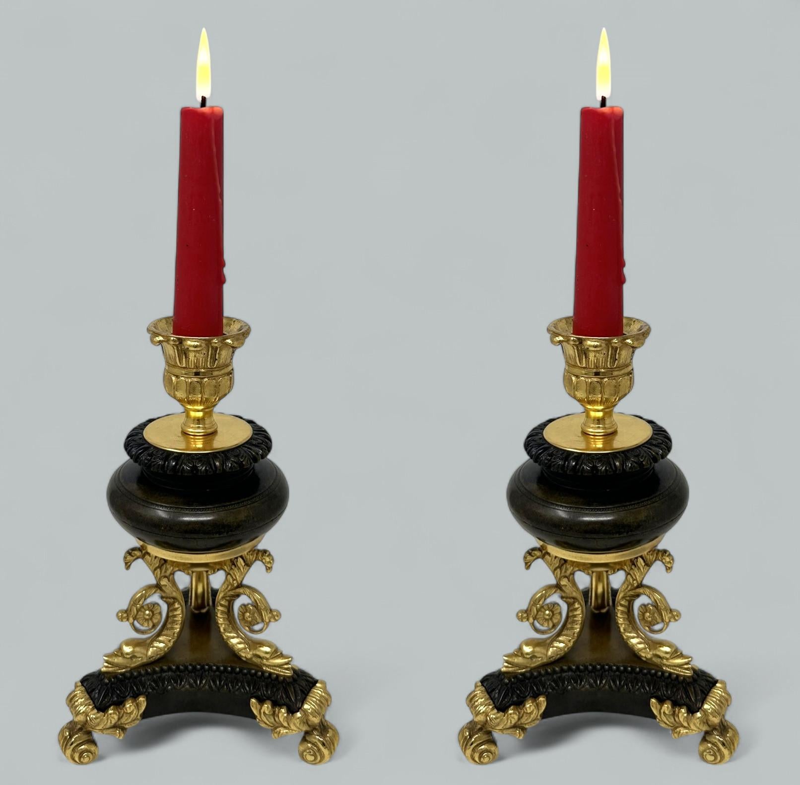 An Exceptionally Stylish Pair of patinated Ormolu Bronze Dore single light Candlesticks of compact proportions, mid Nineteenth Century. 

Superbly formed on finely cast triple scroll dolphin supports, triform bases with ormolu acanthus Leaf