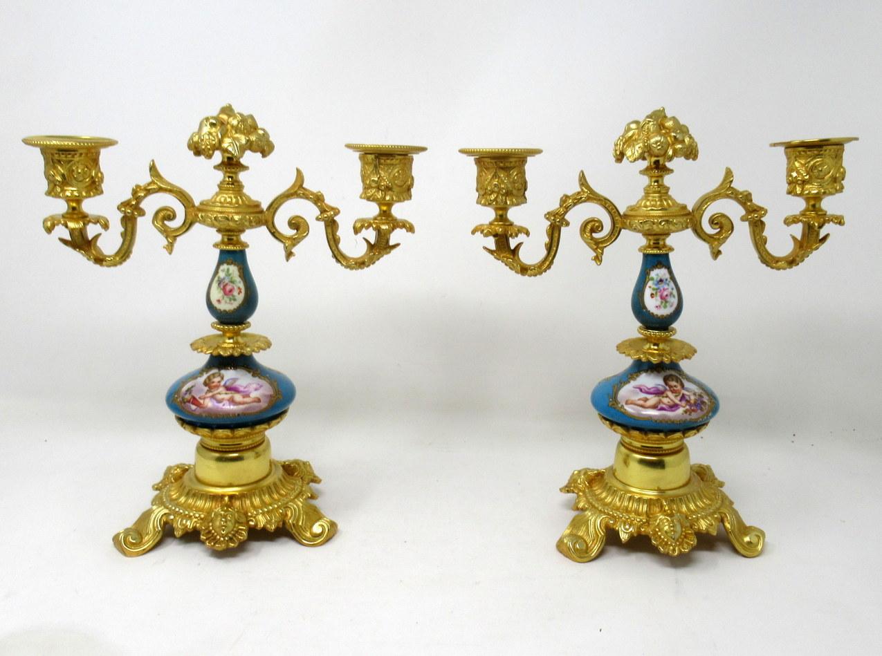 A fine stylish and imposing pair of French two-light table or mantel (fireplace) Sèvres porcelain ormolu-mounted candelabras of outstanding quality, mid-late 19th century.

Each with twin scrolling branch above two porcelain hand decorated celeste