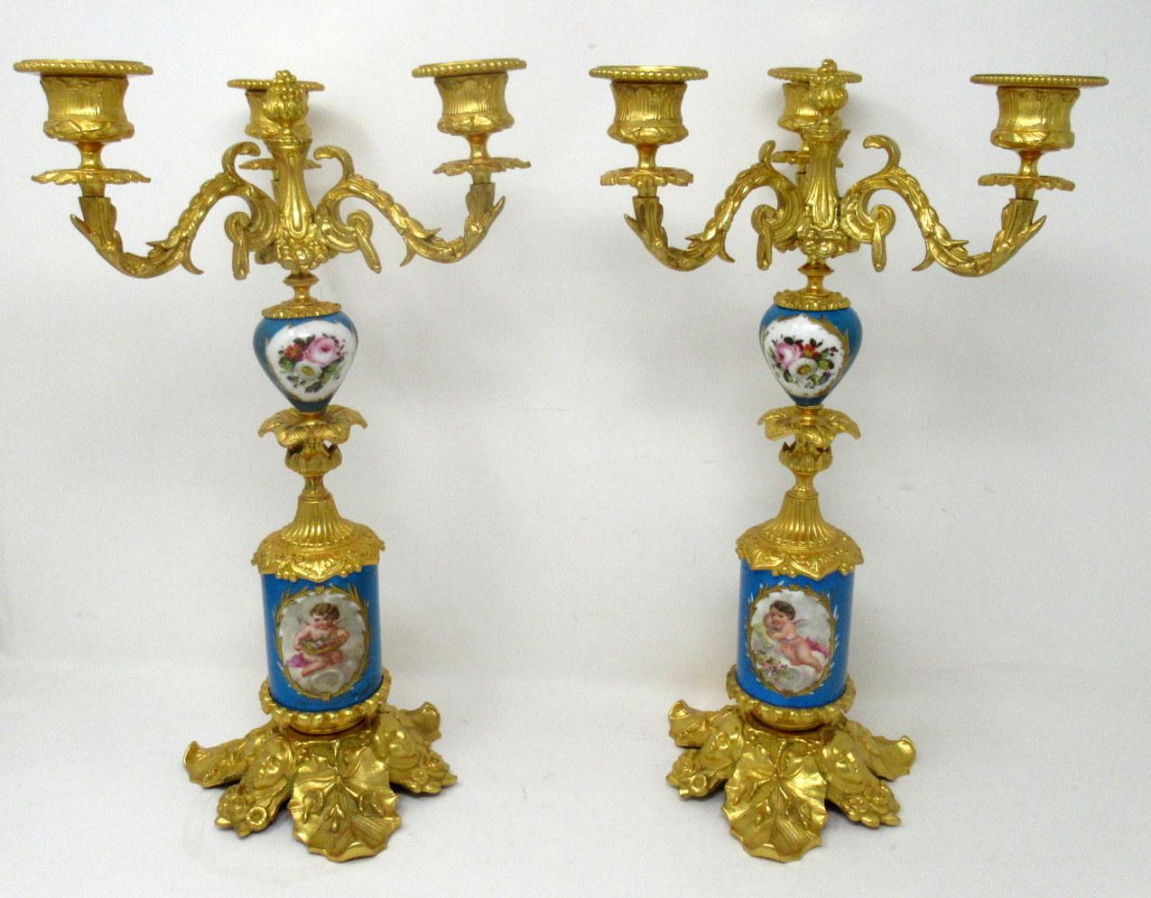 A Fine Stylish and Imposing Pair of French Three Light Table or Mantle Sevres Porcelain Ormolu Mounted Candelabra of outstanding quality. Mid to late Nineteenth Century. 

Each with three scrolling branches above two porcelain hand decorated Celeste