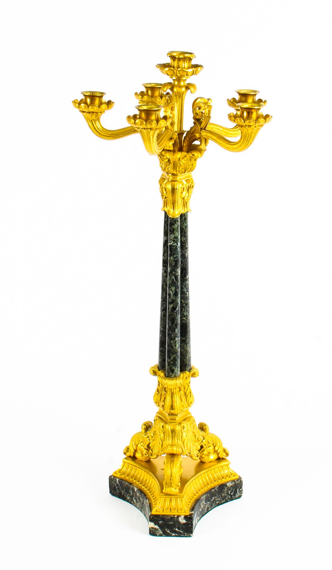 A large and magnificent antique pair of French gilt bronze ormolu and Verde Antico marble six-light candelabra, circa 1850 in date.

The candelabra each feature five reeded scrolling arms with scalloped drip pans and turned nozzles surmounted by a