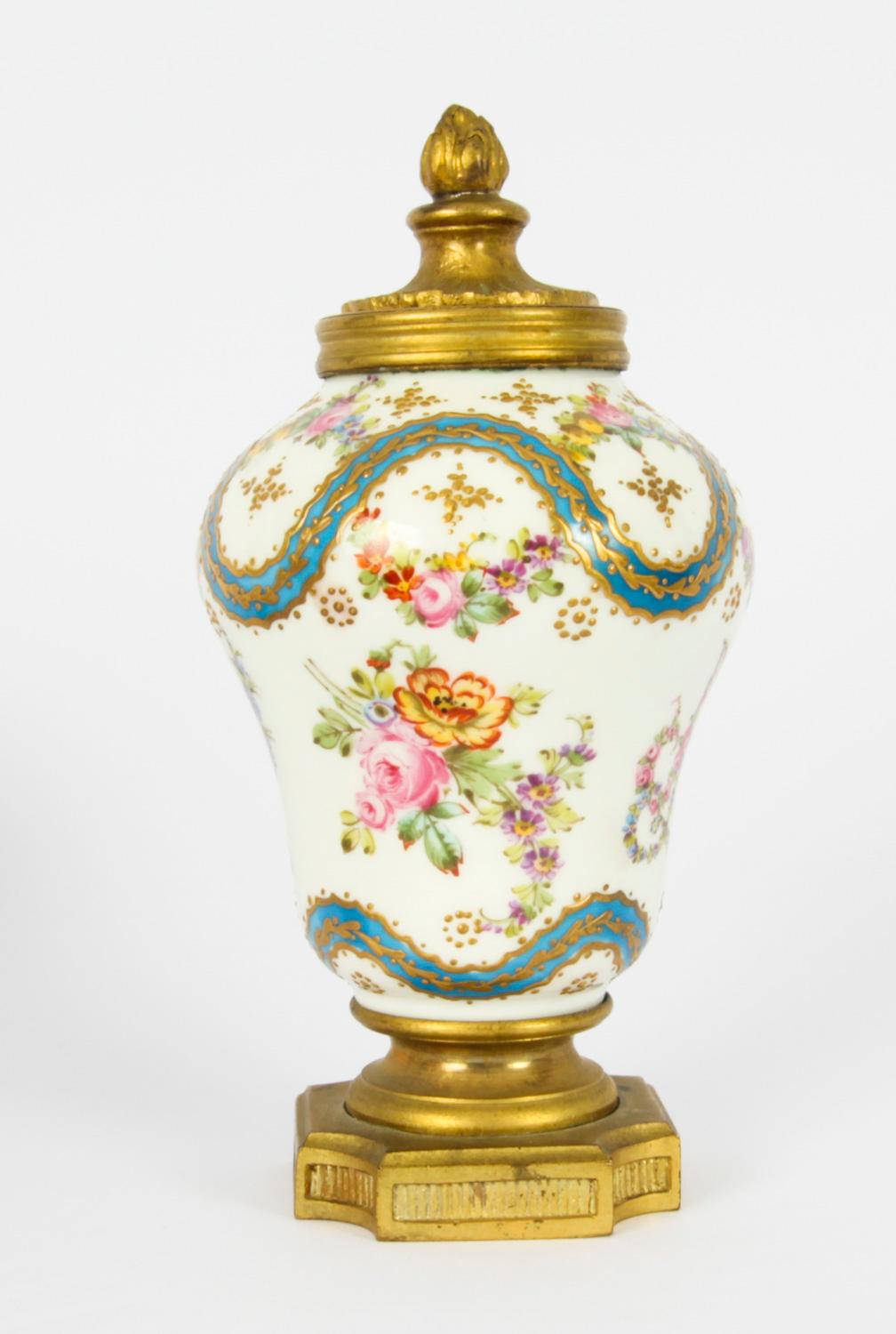 This is a beautiful antique small pair of French Sevres porcelain and ormolu mounted lidded vases, in the Louis XV manner, mid 19th century in date.

The vases are of baluster form and are superbly painted with the monogram of Marie Antoinette