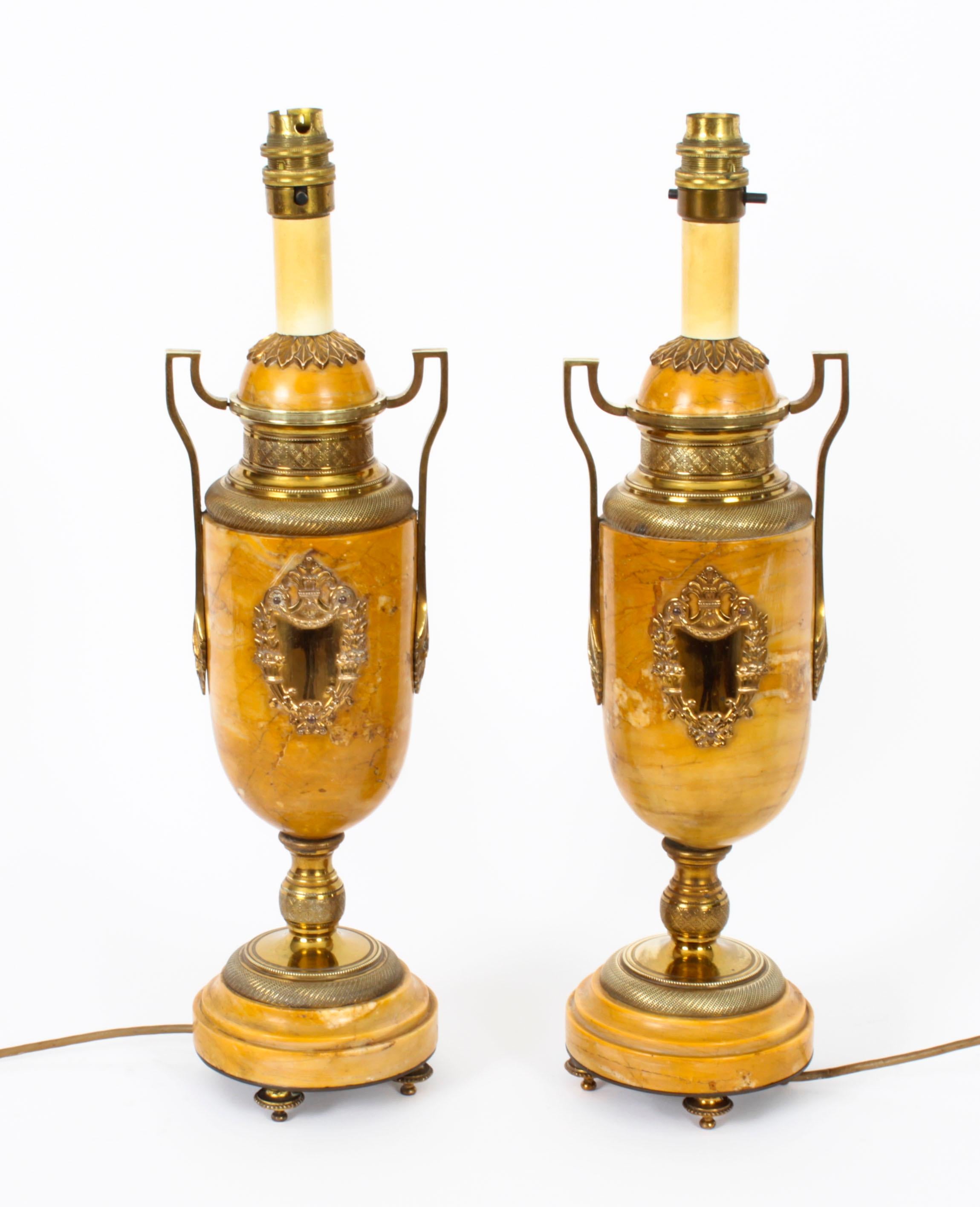 An antique pair of French ormolu mounted and Giallo di Siena marble Neo Classical table lamps, Circa 1870 in date.
 
The pair are of baluster form with twin ormolu handles and ormolu cartouches, raised on circular socles and plinths with ormolu
