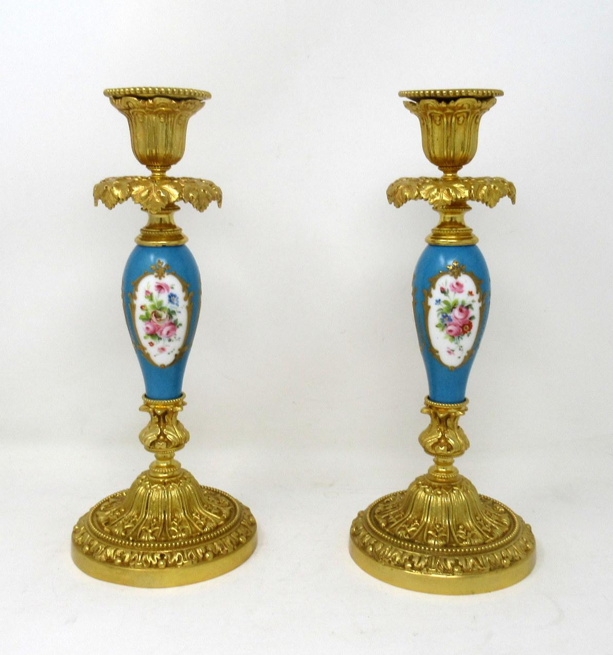 A fine pair of stylish and imposing French ormolu and Sèvres porcelain heavy gauge single light candlesticks of outstanding quality and of generous proportions, first half of the 19th century.

Each with a central ovoid form porcelain support