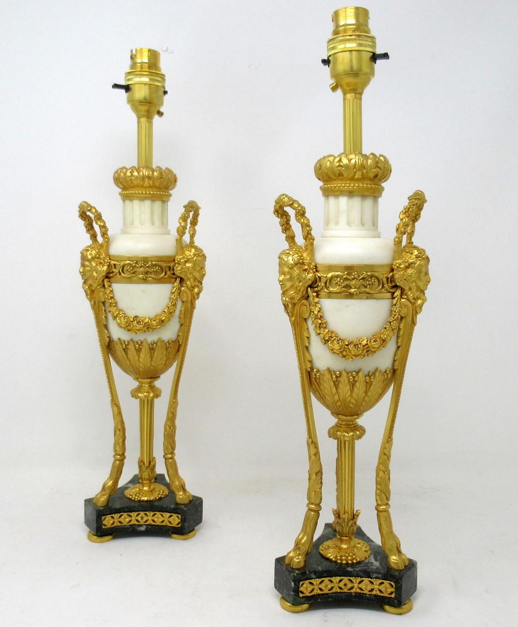 An exceptionally fine quality pair of French heavy gauge chisel cast ormolu-mounted statutory marble garniture urns, of elegant tall proportions, of French origin, now professionally converted to a pair electrical table lamps. First quarter of the