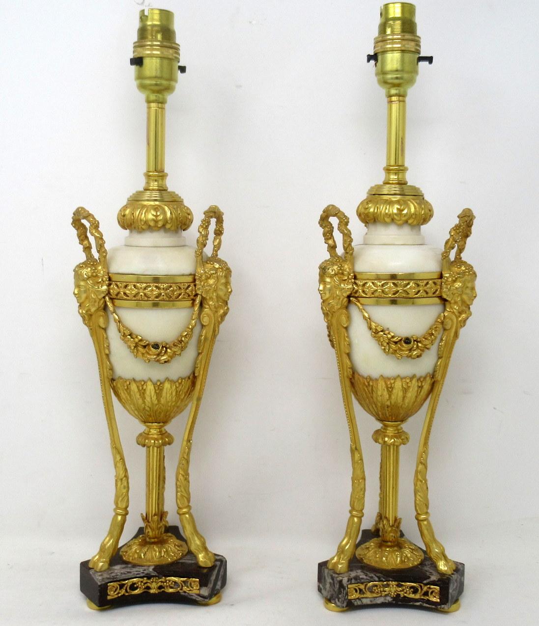 An exceptionally fine quality pair of French heavy Gauge Chisel Cast Ormolu-Mounted Statutory cream marble Garniture Urns, of elegant tall proportions, of French origin, now professionally converted to a pair Electrical table lamps. First quarter of