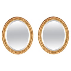 Coppia di specchi ovali rococò francesi in legno dorato del XIX secolo 58x49cm