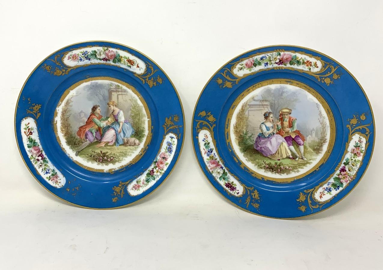 An exceptionally well hand painted identical pair French Sevres style hard paste porcelain circular cabinet plates, last half of the nineteenth century.

The central reserve with a hand painting depicting a romantic couple in Landscapes wearing