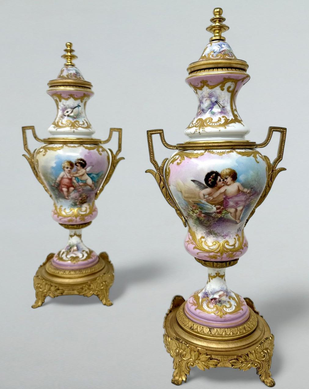 Stunning Pair of French Sevres Soft Paste Enameled Porcelain and Ormolu Twin Handle Table or Mantle Urns of traditional urn form and of outstanding quality, and good size proportions, each raised on a square stepped base with very ornate scrolling