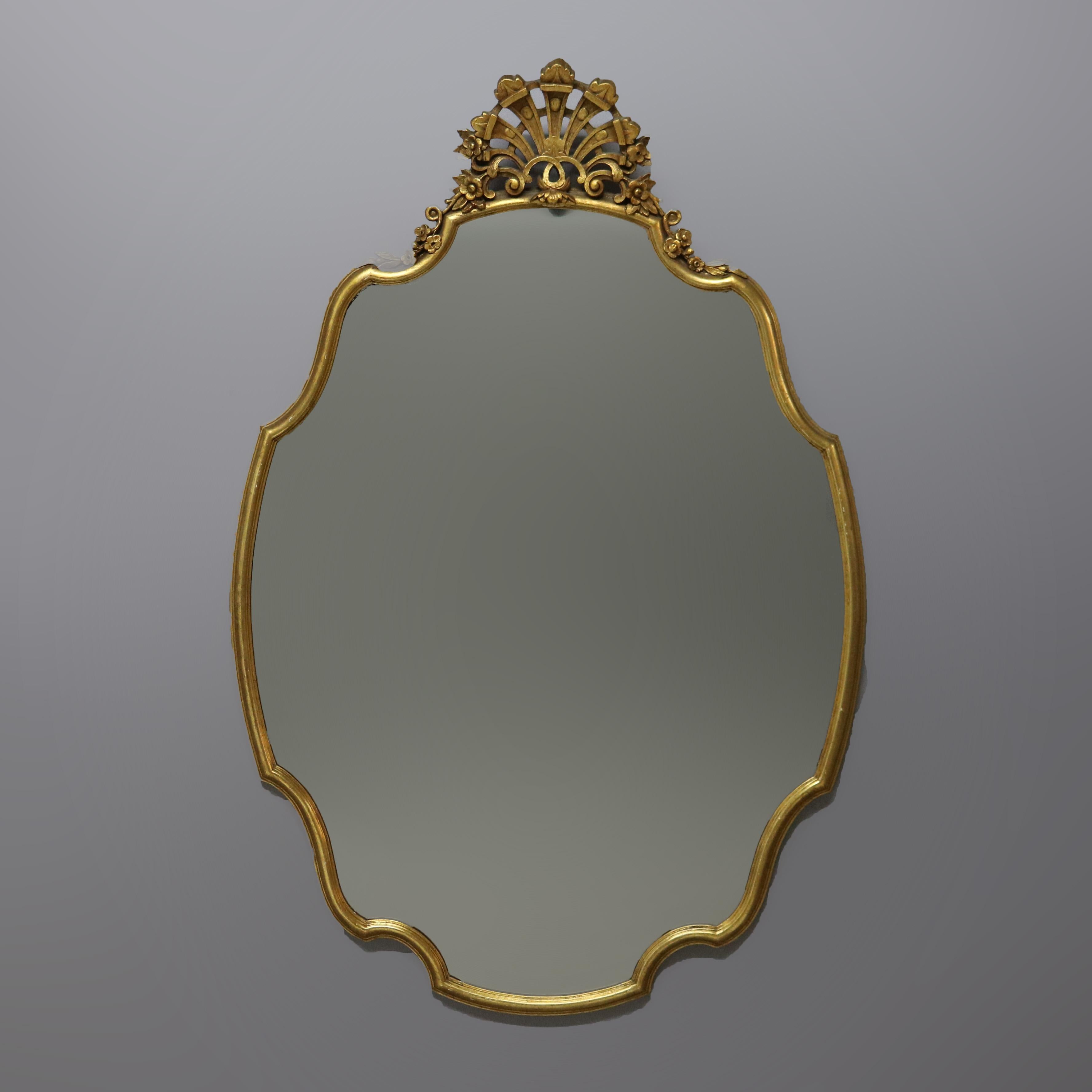 An antique pair of matching French style wall mirrors offer giltwood construction with shaped mirrors having reticulated foliate crests, c1930.

Measures- 47.25''H x 31.5''W x 3.5''D

Catalogue Note: Ask about DISCOUNTED DELIVERY RATES available to